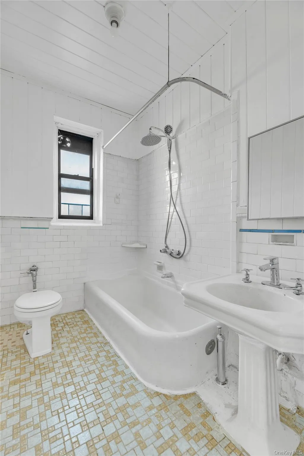Bathroom with tile walls and washtub / shower combination Bathroom with tile walls and washtub / shower combination