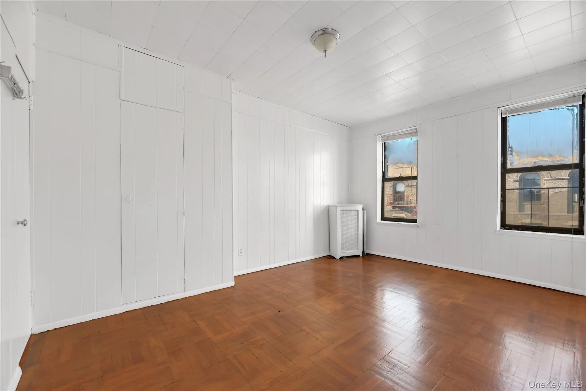 Spare room with radiator and wooden walls Spare room with radiator and wooden walls