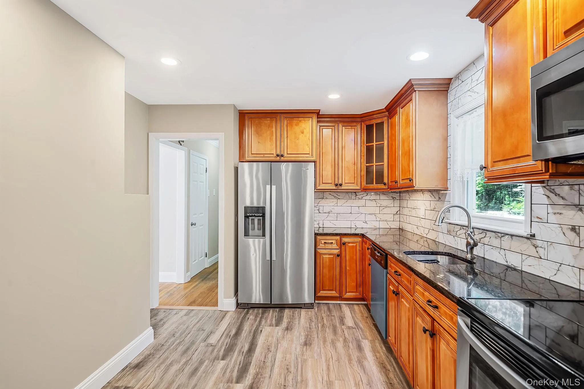 Wood bainets, granite, tops and tiled backsplash Wood bainets, granite, tops and tiled backsplash