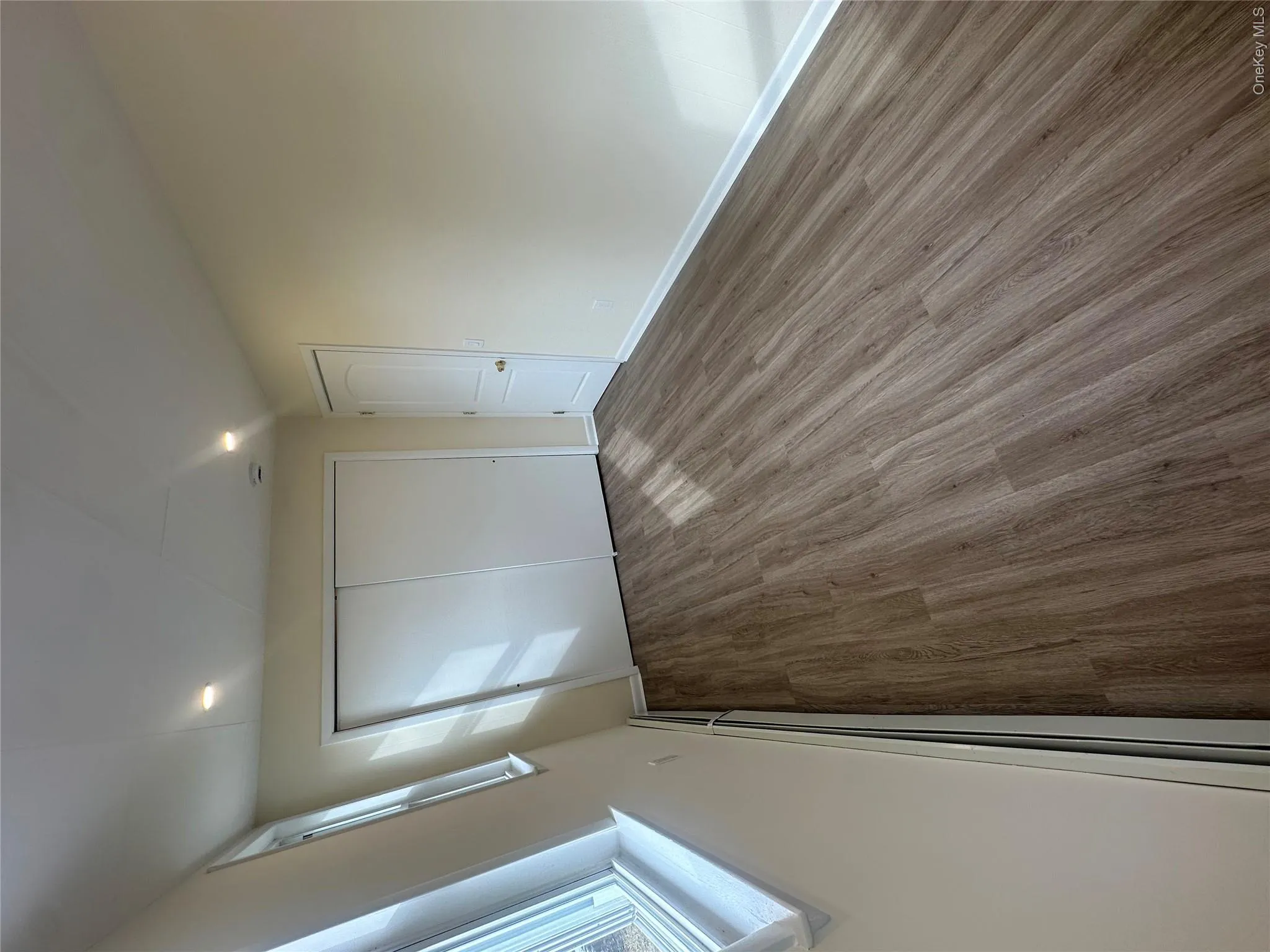 Unfurnished bedroom with a baseboard radiator, and a closet Unfurnished bedroom with a baseboard radiator, and a closet