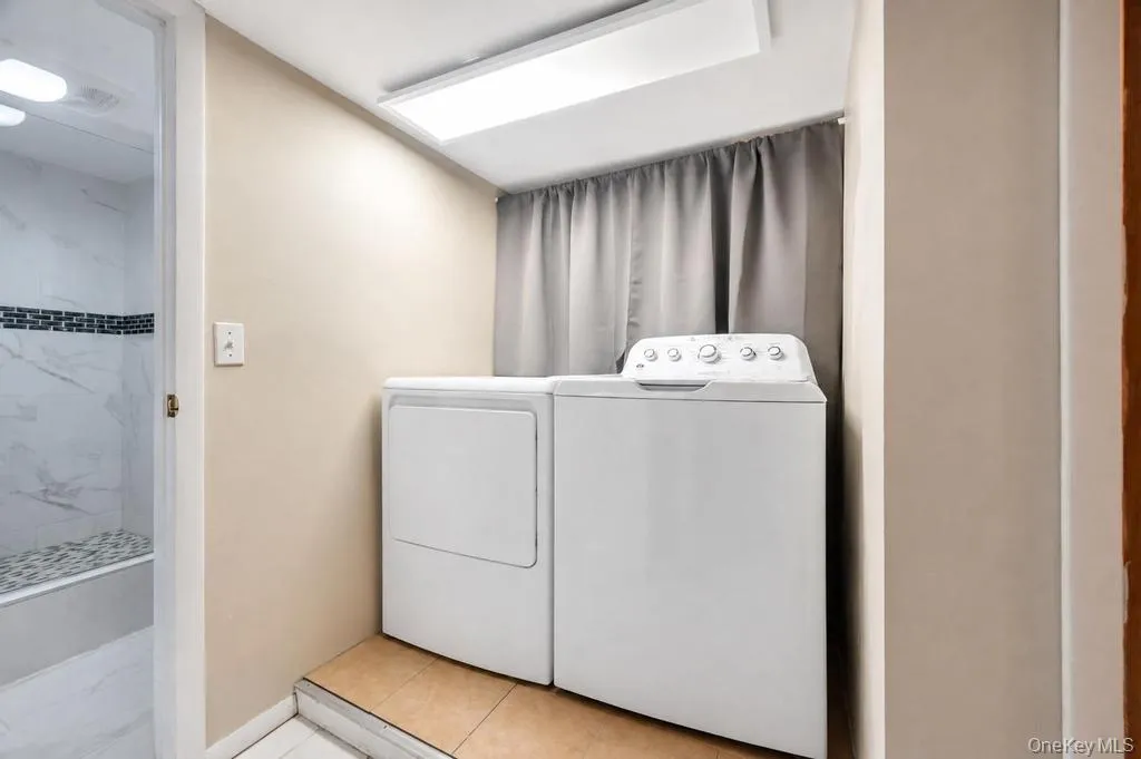 Dedicated laundry area featuring a white washer and dryer pair Dedicated laundry area featuring a white washer and dryer pair