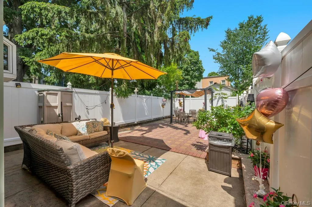 Expansive patio area featuring a combination of concrete and brick pavers Expansive patio area featuring a combination of concrete and brick pavers