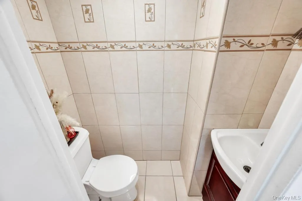 Ceramic tile walls featuring decorative accent bands and framed motifs Ceramic tile walls featuring decorative accent bands and framed motifs