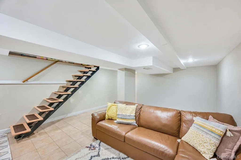Contemporary floating staircase with wood-finish treads and a black metal frame Contemporary floating staircase with wood-finish treads and a black metal frame