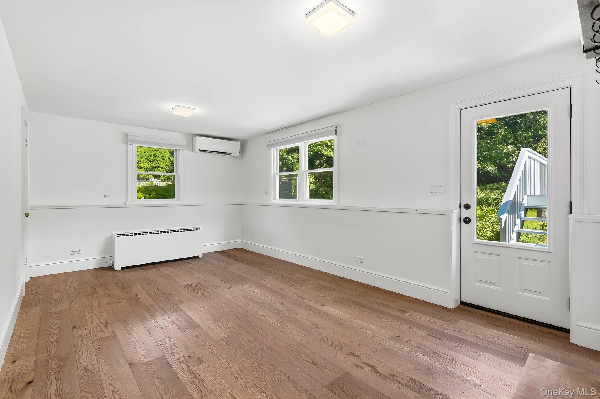 Lower level office/den door to back yard, door to garage and access to basement Lower level office/den door to back yard, door to garage and access to basement