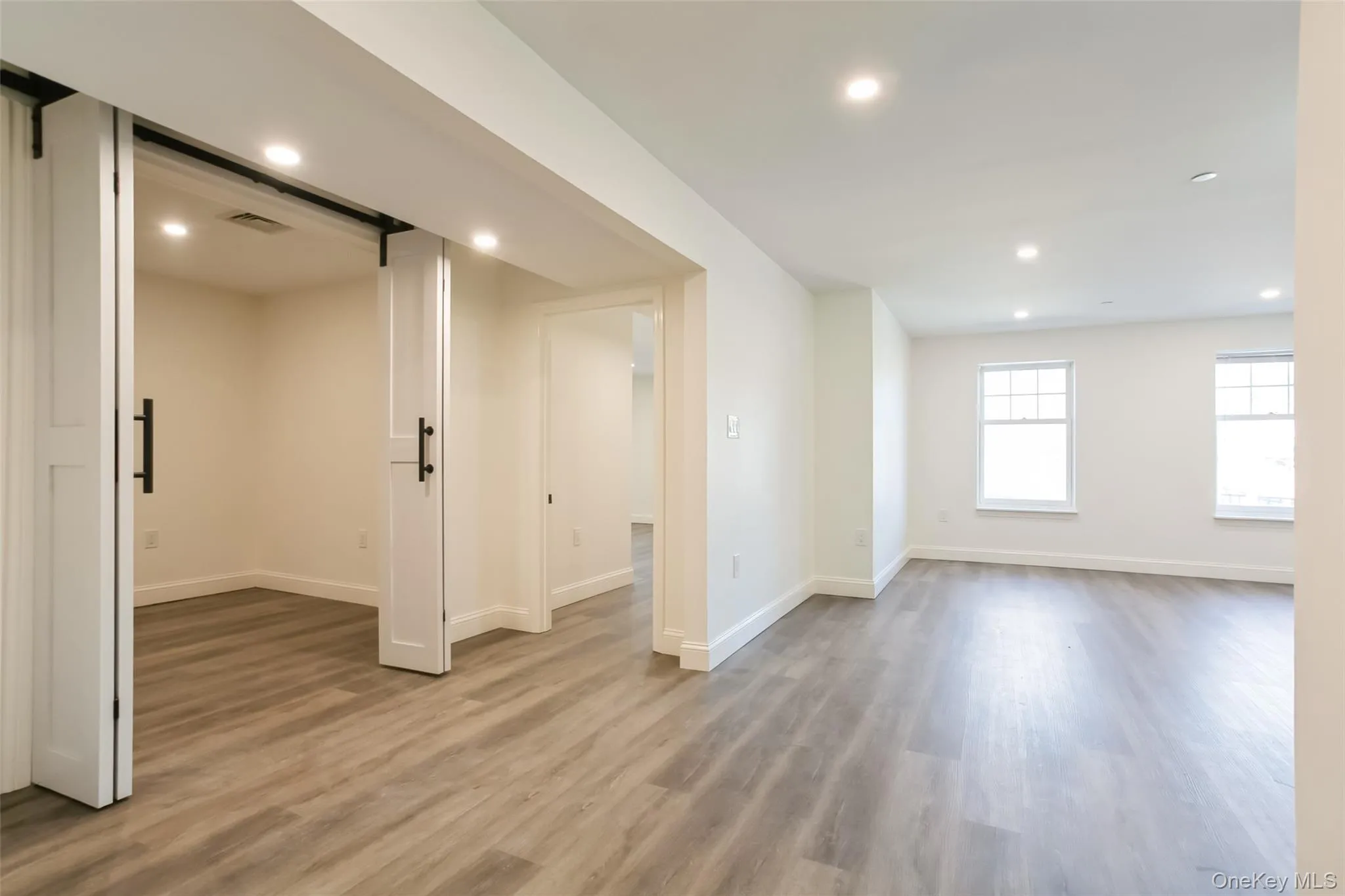 Unfurnished room with recessed lighting, visible vents, baseboards, and light wood finished floors Unfurnished room with recessed lighting, visible vents, baseboards, and light wood finished floors