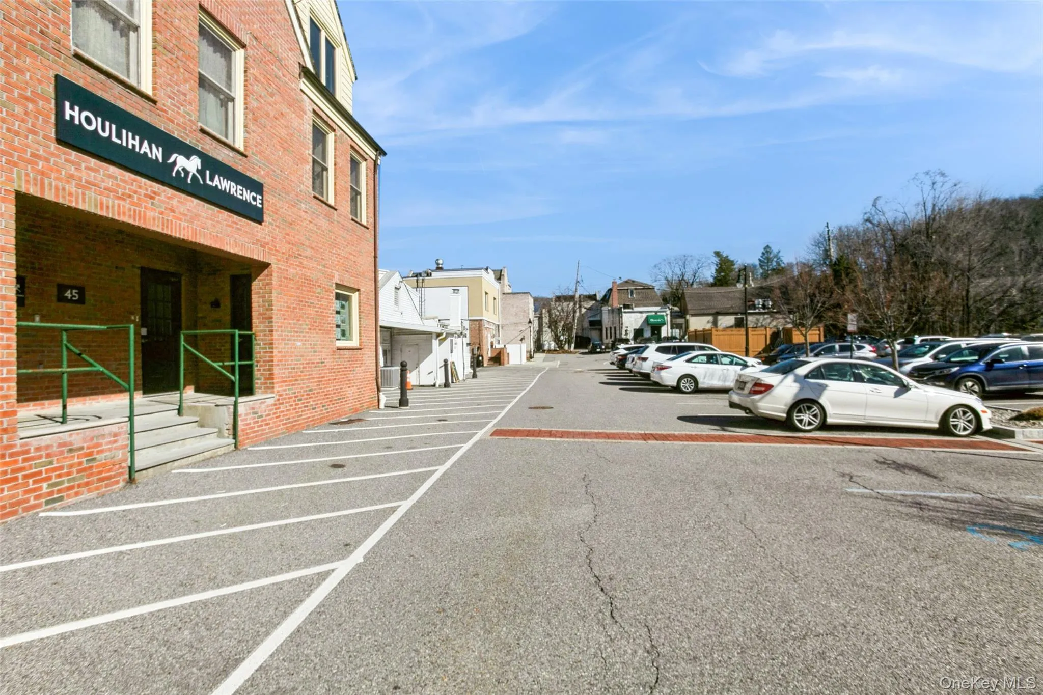 Uncovered parking lot featuring a residential view Uncovered parking lot featuring a residential view