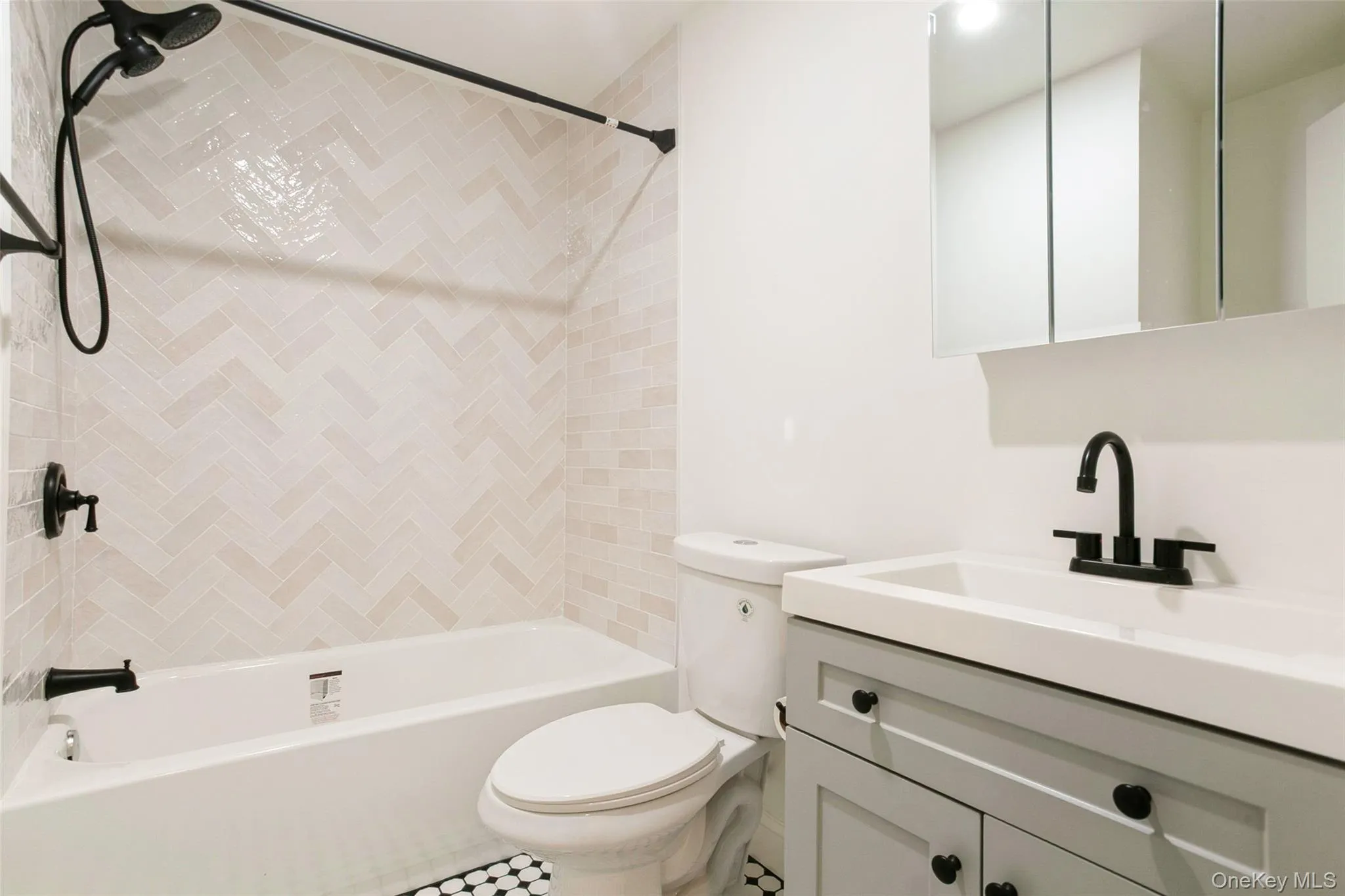 Bathroom featuring tub / shower combination, toilet, and vanity Bathroom featuring tub / shower combination, toilet, and vanity
