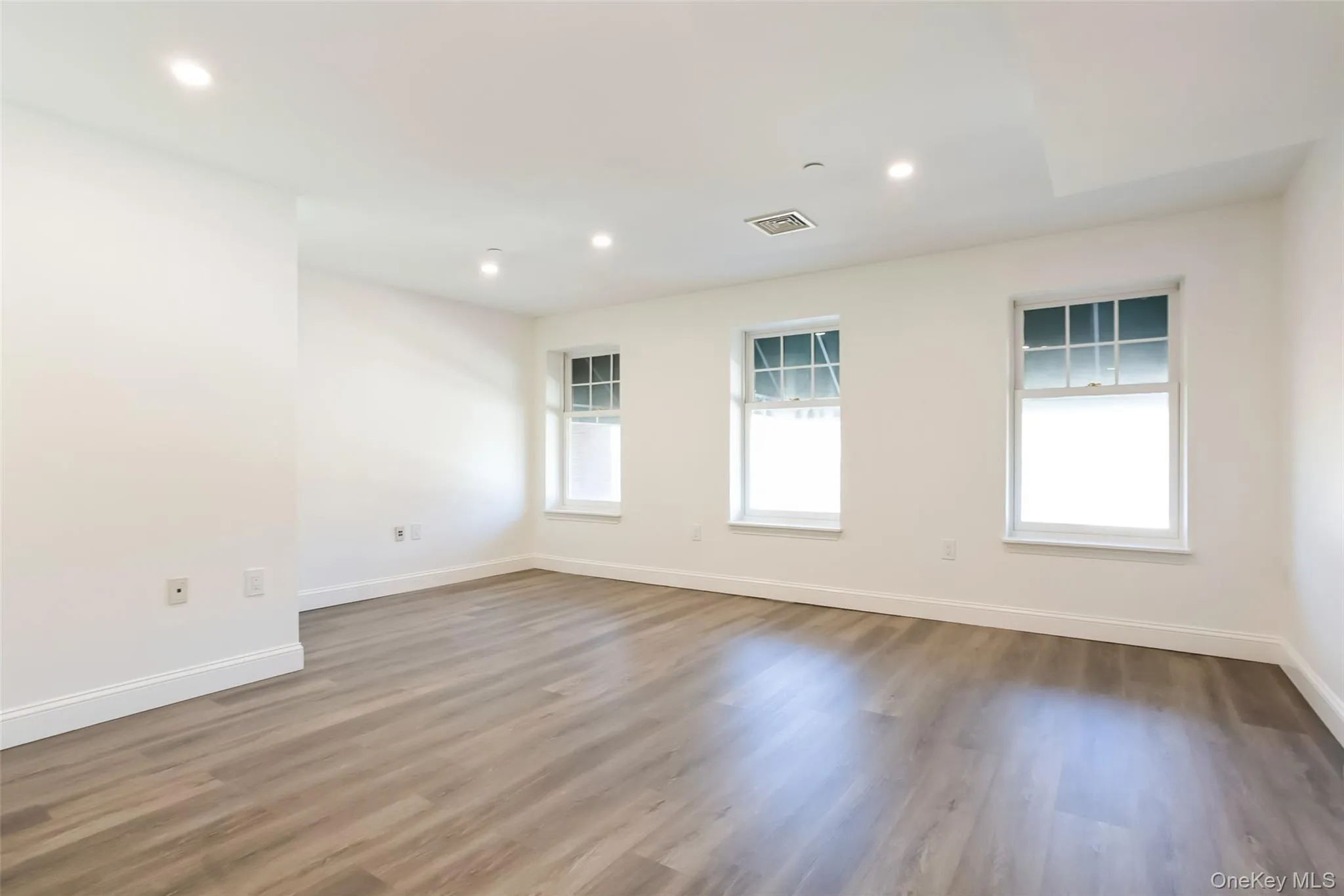 Spare room featuring recessed lighting, visible vents, baseboards, and wood finished floors Spare room featuring recessed lighting, visible vents, baseboards, and wood finished floors