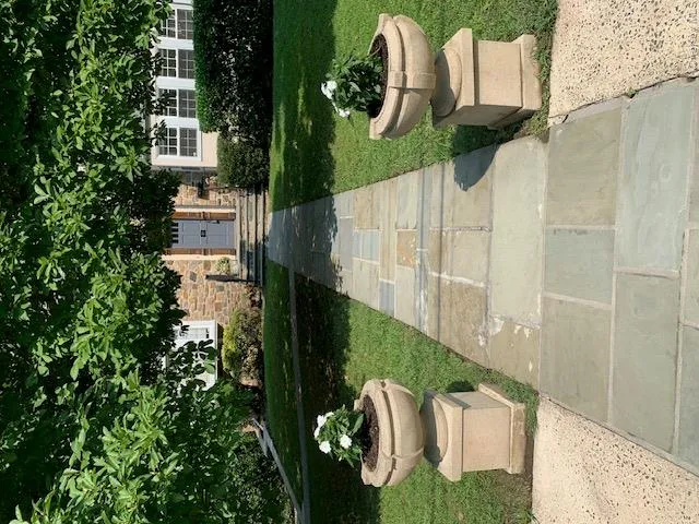 Large setback of house with handsome planters Large setback of house with handsome planters