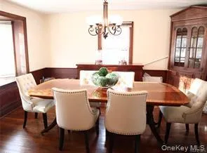 Large dining room with bay window overlooking front lawn Large dining room with bay window overlooking front lawn