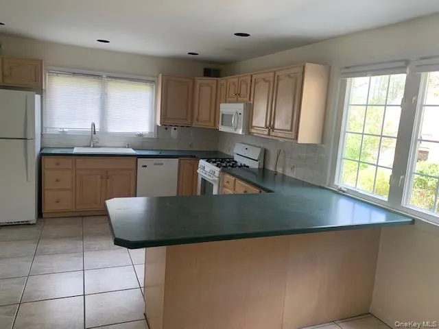 Kitchen with L shaped island counter Kitchen with L shaped island counter