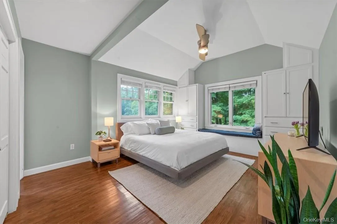 Bedroom with vaulted ceiling, hardwood / wood-style floors, and ceiling fan Bedroom with vaulted ceiling, hardwood / wood-style floors, and ceiling fan