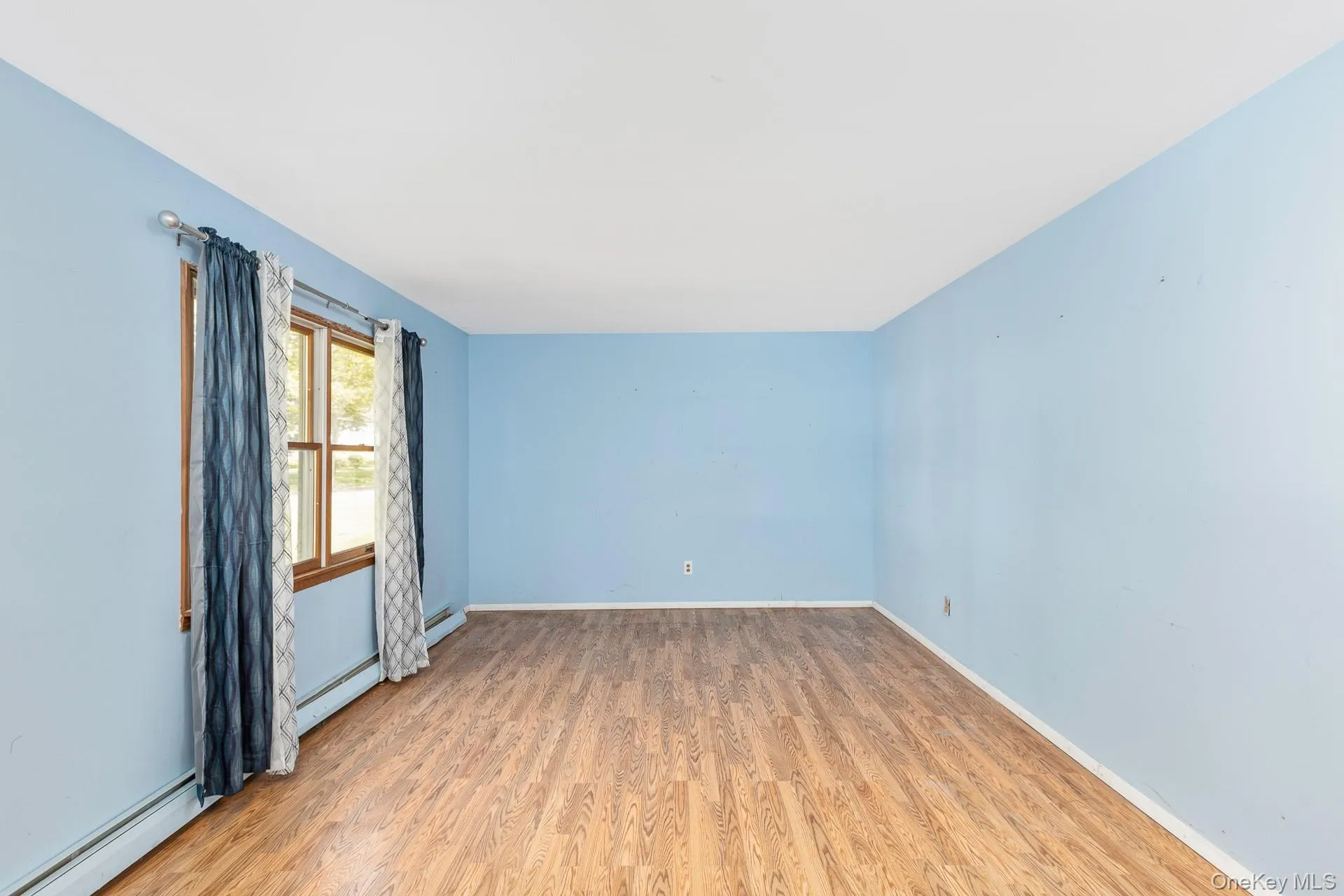 Light blue walls, and a multi-pane window with wood trim. Light blue walls, and a multi-pane window with wood trim.