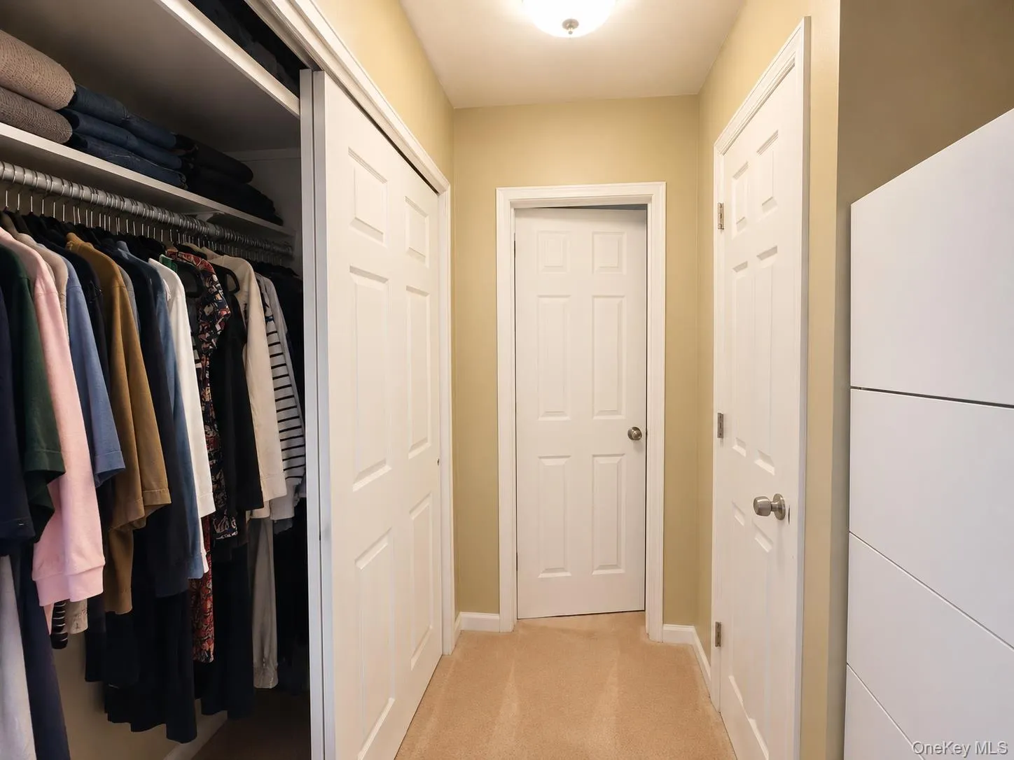 Entrance to bathroom with closet space on either side Entrance to bathroom with closet space on either side