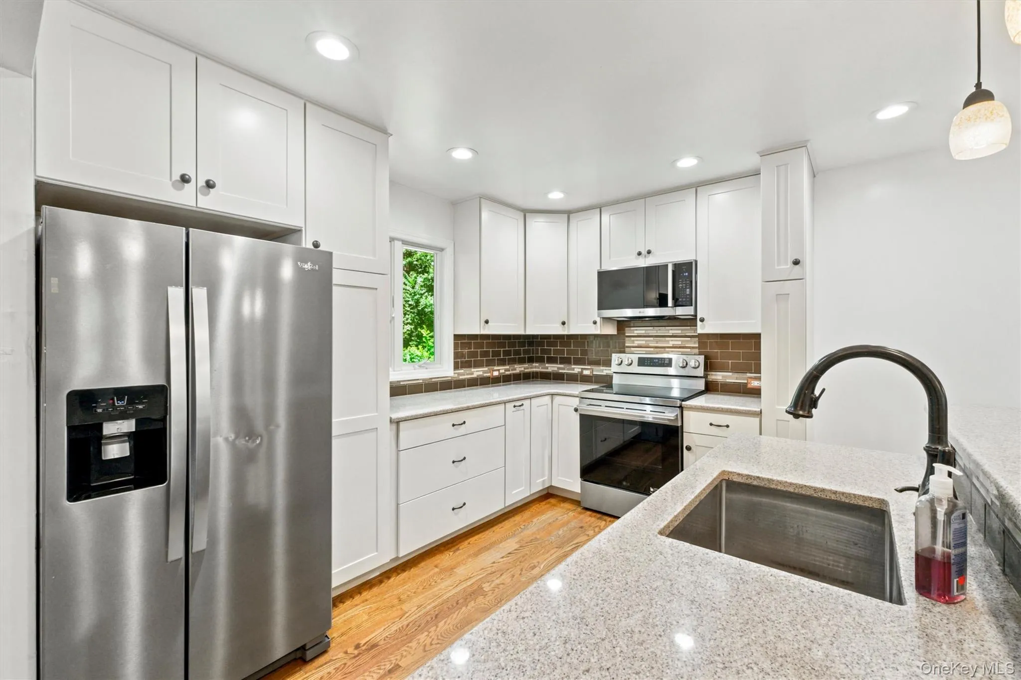 Deep stainless steel sink in the island and pendent lights. Deep stainless steel sink in the island and pendent lights.