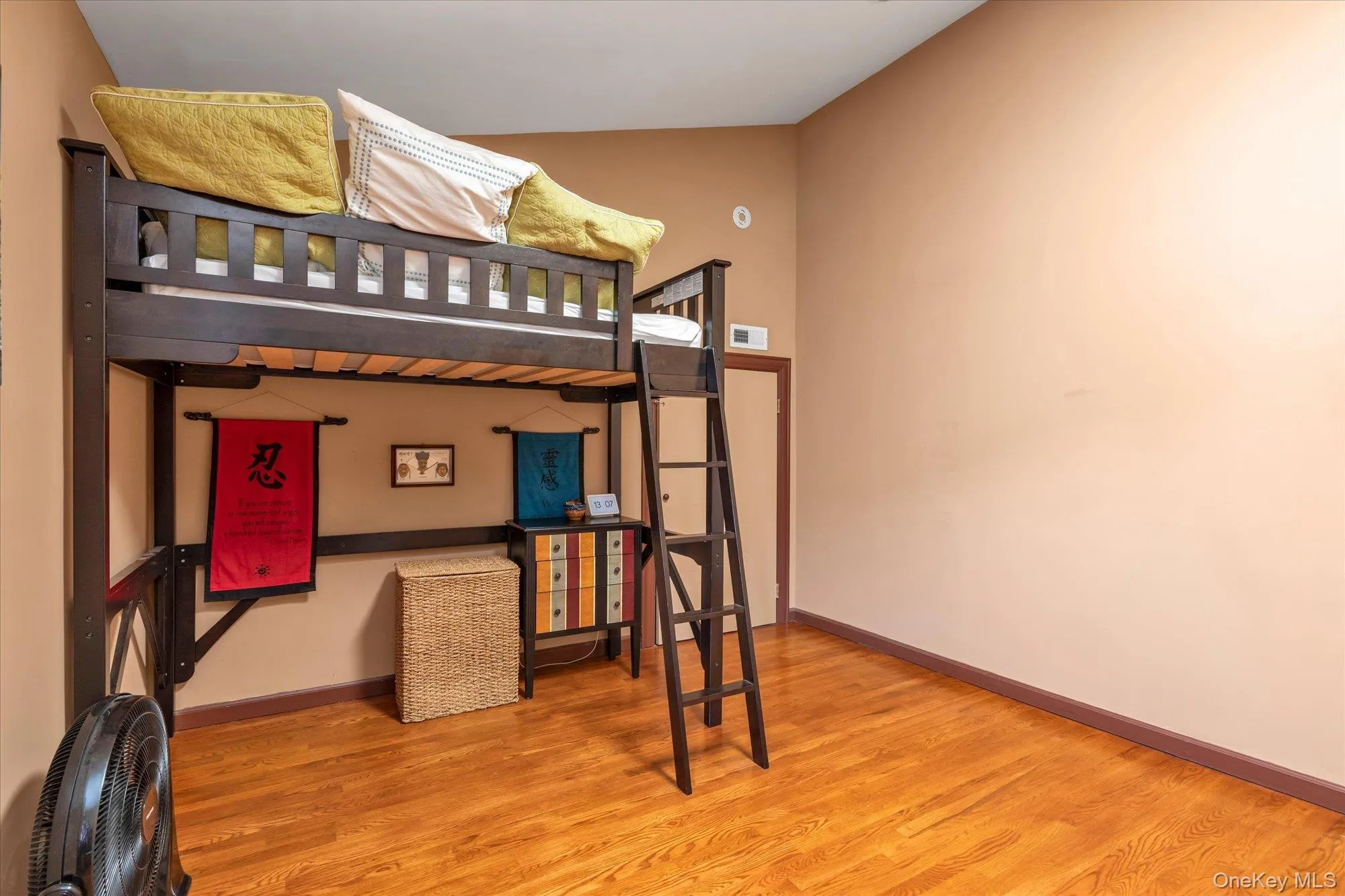Loft with 3rd bedroom or guest quarters with hardwood flooring and neutral-toned walls Loft with 3rd bedroom or guest quarters with hardwood flooring and neutral-toned walls
