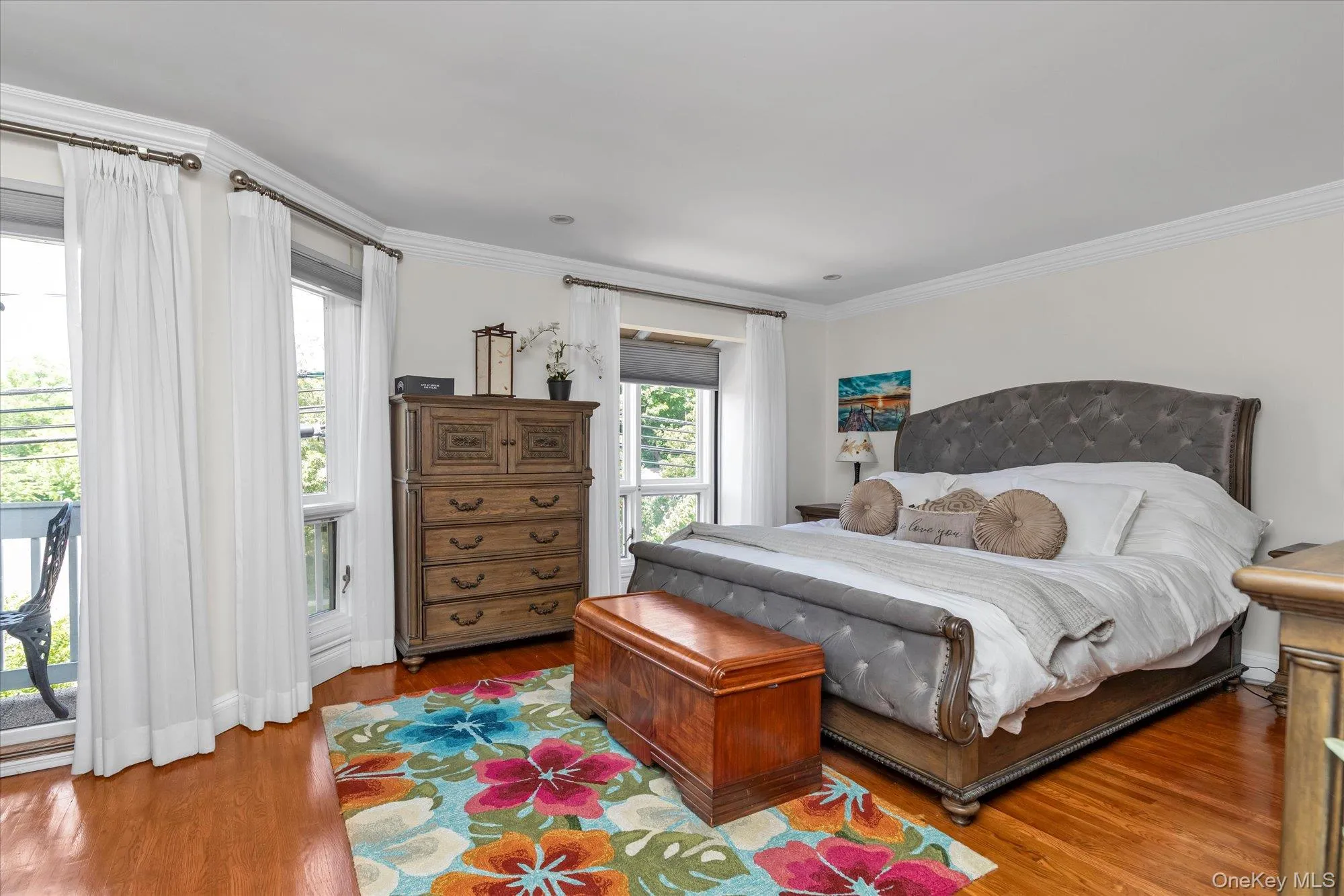 Master bedroom with full ensuite bath and shower. Hardwood-finish flooring, white walls, and extensive crown molding and private balcony. Master bedroom with full ensuite bath and shower. Hardwood-finish flooring, white walls, and extensive crown molding and private balcony.