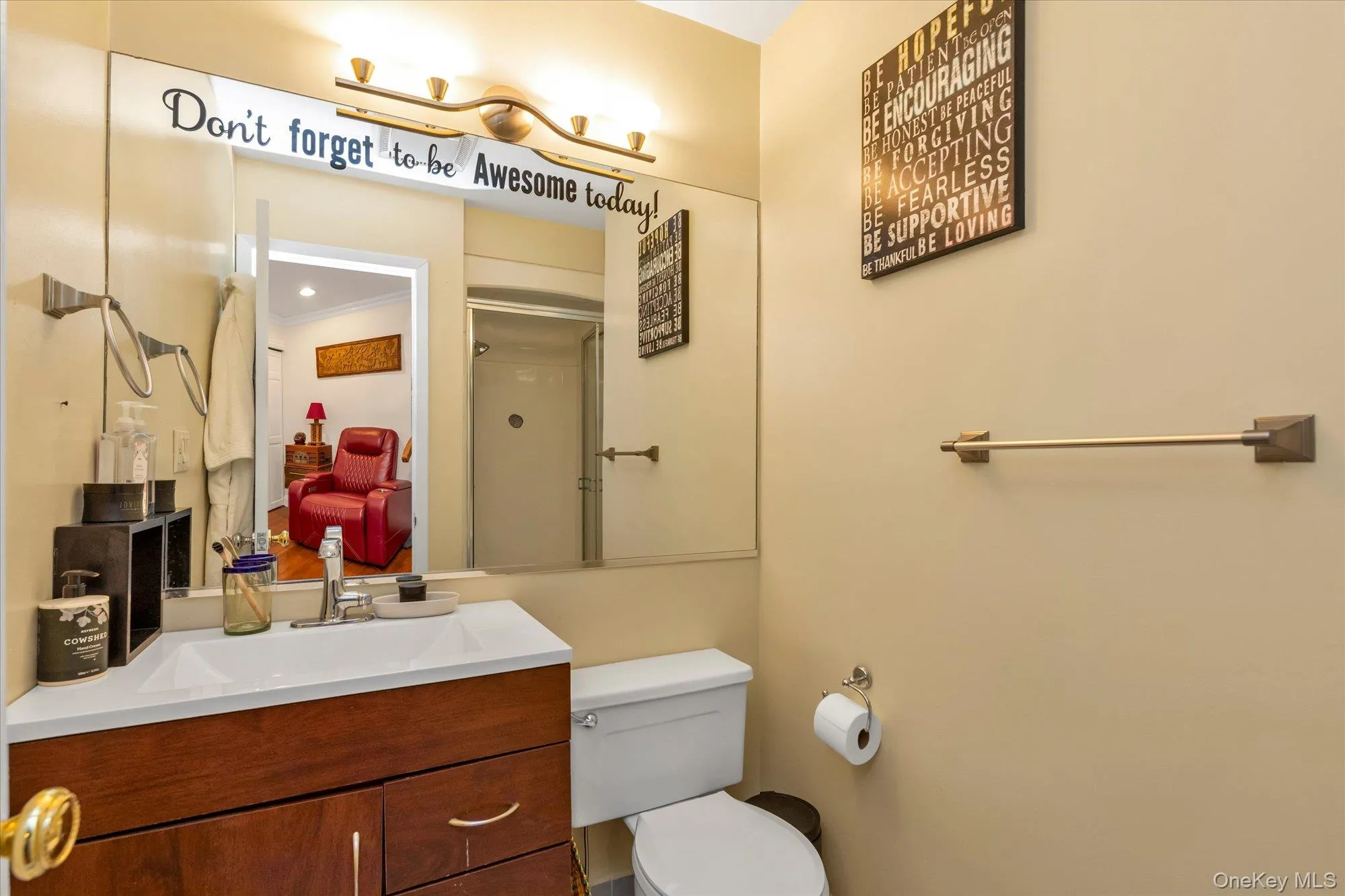 2nd bathroom featuring a wood-finish vanity with an integrated sink, full shower, a large wall-mounted mirror, and a wall-mounted light fixture 2nd bathroom featuring a wood-finish vanity with an integrated sink, full shower, a large wall-mounted mirror, and a wall-mounted light fixture