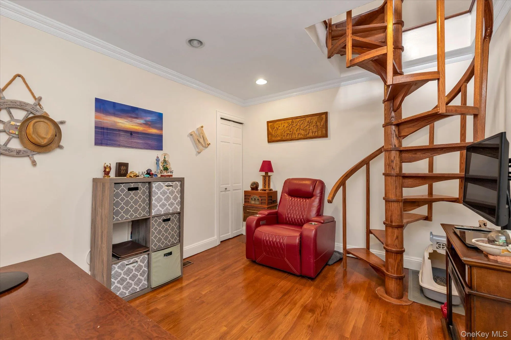 2nd bedroom with wood spiral staircase with open risers and wood-finish flooring 2nd bedroom with wood spiral staircase with open risers and wood-finish flooring