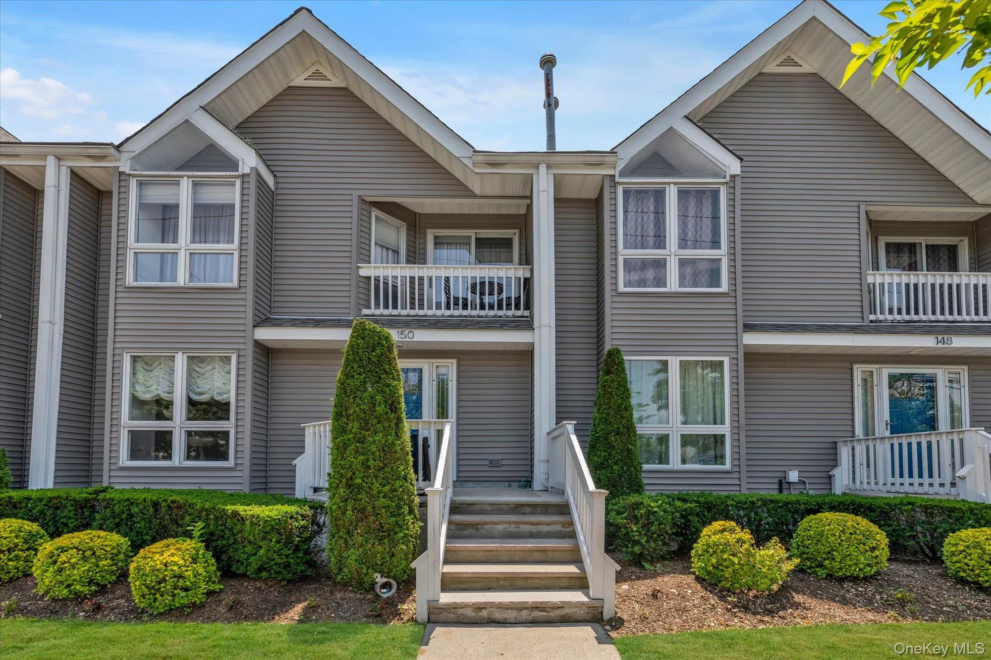 Multi-story residential facade featuring horizontal siding and contrasting white trim Multi-story residential facade featuring horizontal siding and contrasting white trim