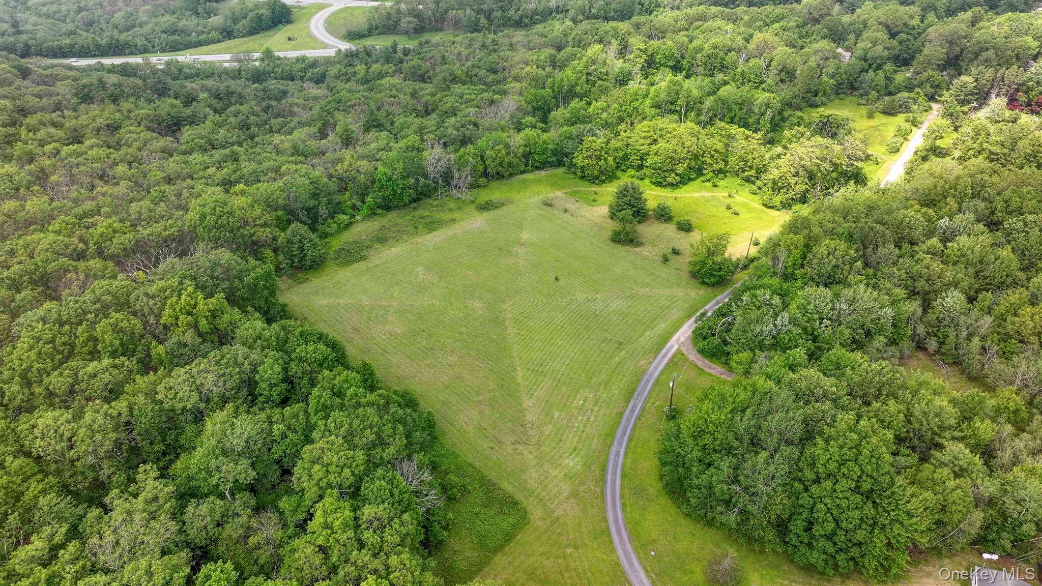 Aerial overview of property's location with a heavily wooded area Aerial overview of property's location with a heavily wooded area