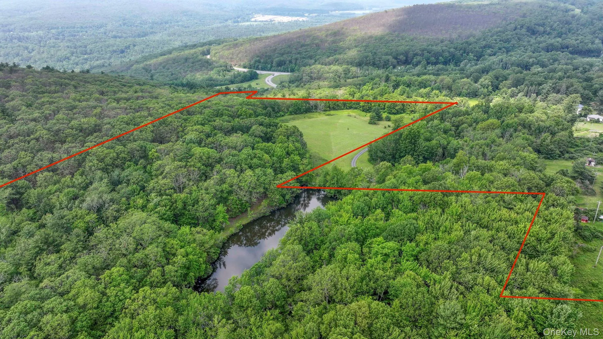 Aerial overview of property's location with a large body of water and property boundaries highlighted Aerial overview of property's location with a large body of water and property boundaries highlighted