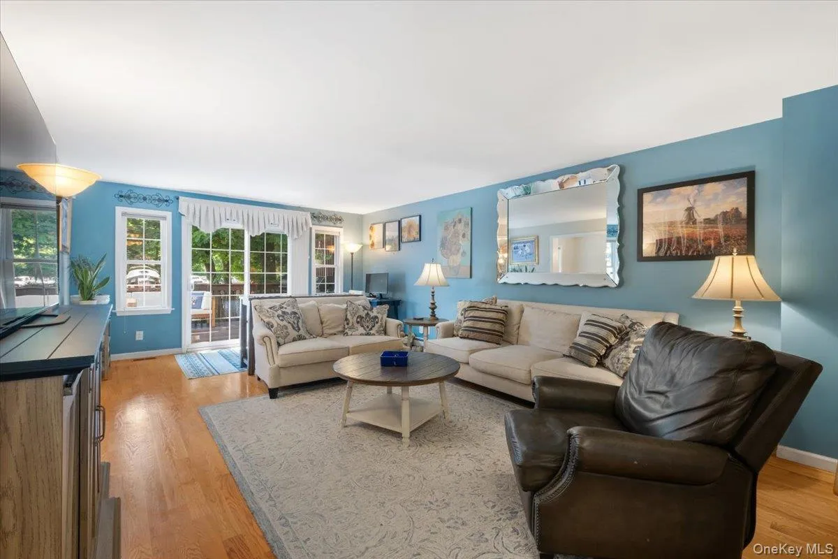 hw floors, sliding glass doors to spacious deck and patio area hw floors, sliding glass doors to spacious deck and patio area