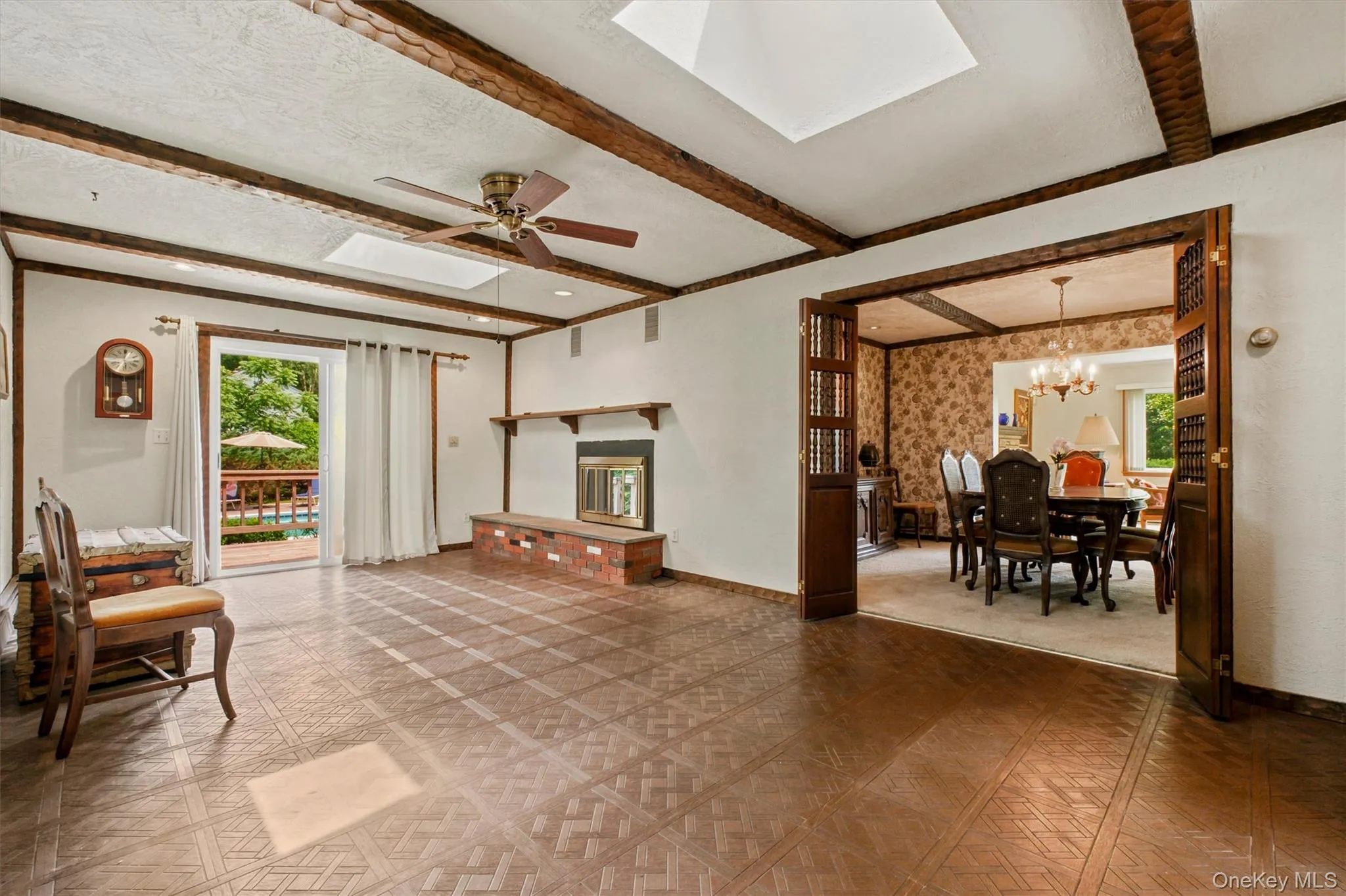 Large family room w/wood-burning fireplace, skylights & beamed ceiling accents. This home has character. Large family room w/wood-burning fireplace, skylights & beamed ceiling accents. This home has character.