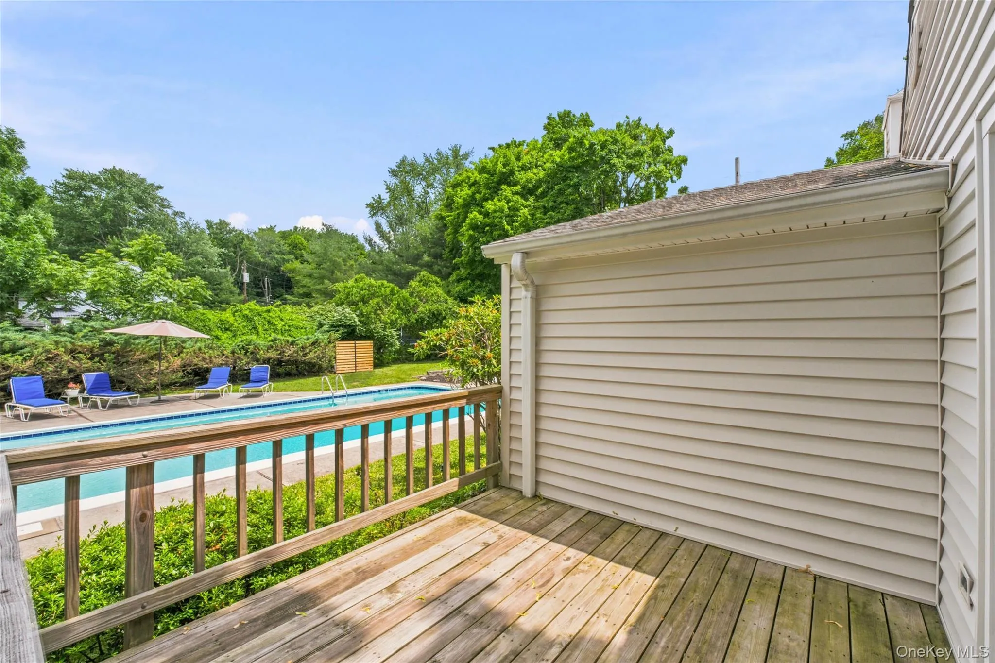 Side deck off family room leads to outside pool and yard. Side deck off family room leads to outside pool and yard.