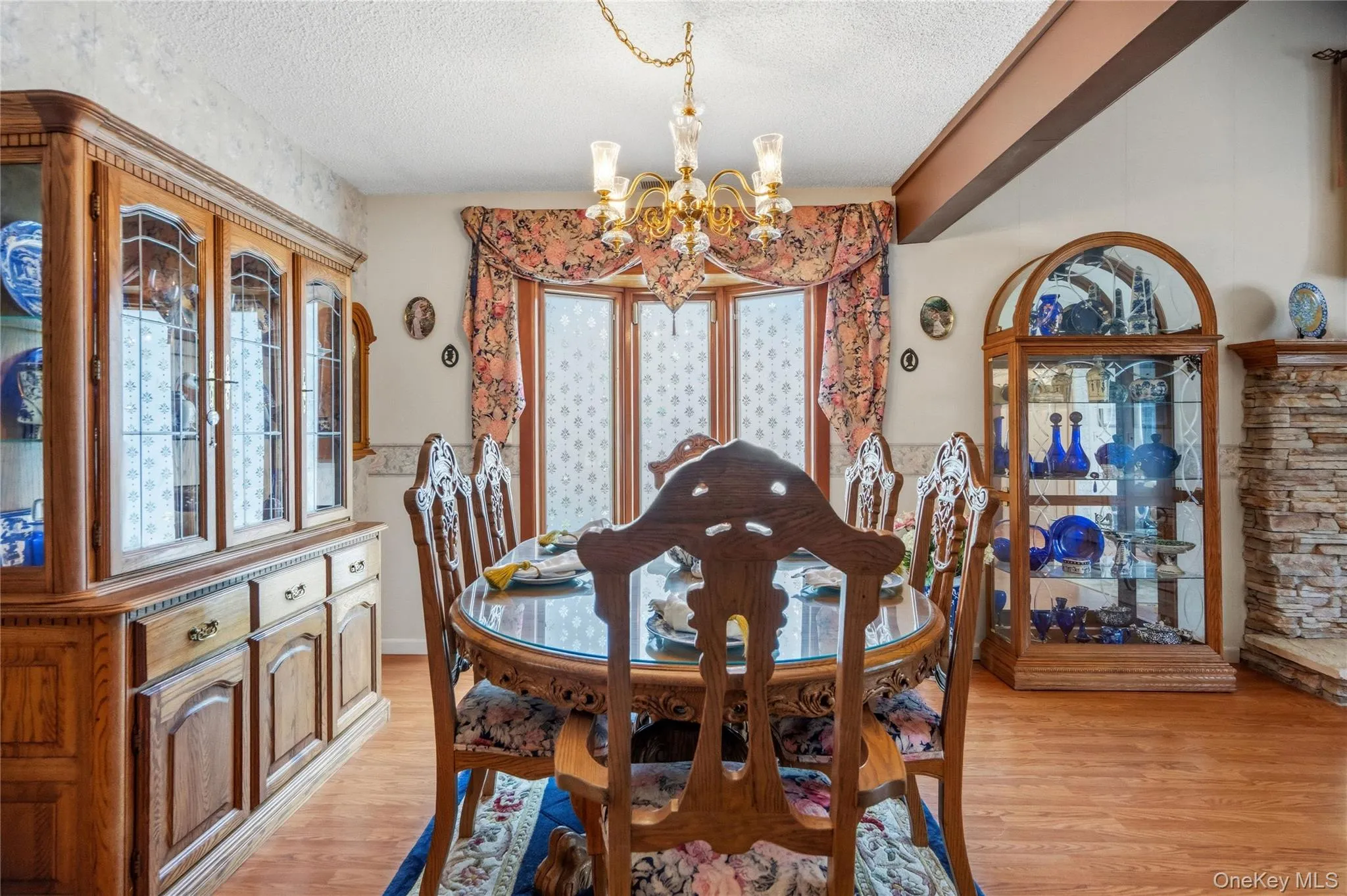 The spacious dining area can accommodate a large table & china cabinet, and features a decorative chandelier and large triple windows. The spacious dining area can accommodate a large table & china cabinet, and features a decorative chandelier and large triple windows.