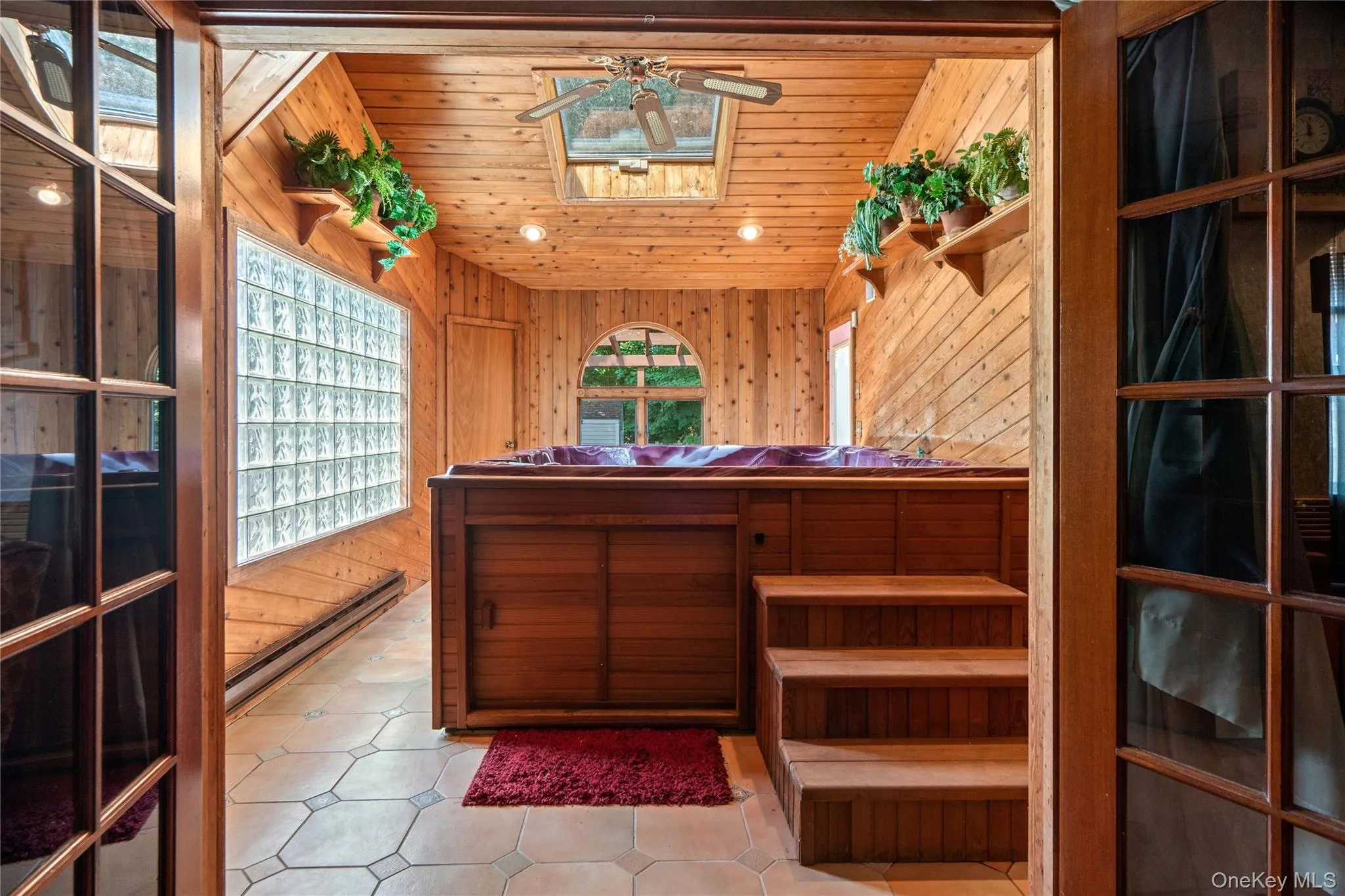 Enter off the primary bedroom and unwind in your own private retreat. The warm natural wood walls & ceiling of the hot tub room create a cozy atmosphere... Enter off the primary bedroom and unwind in your own private retreat. The warm natural wood walls & ceiling of the hot tub room create a cozy atmosphere...