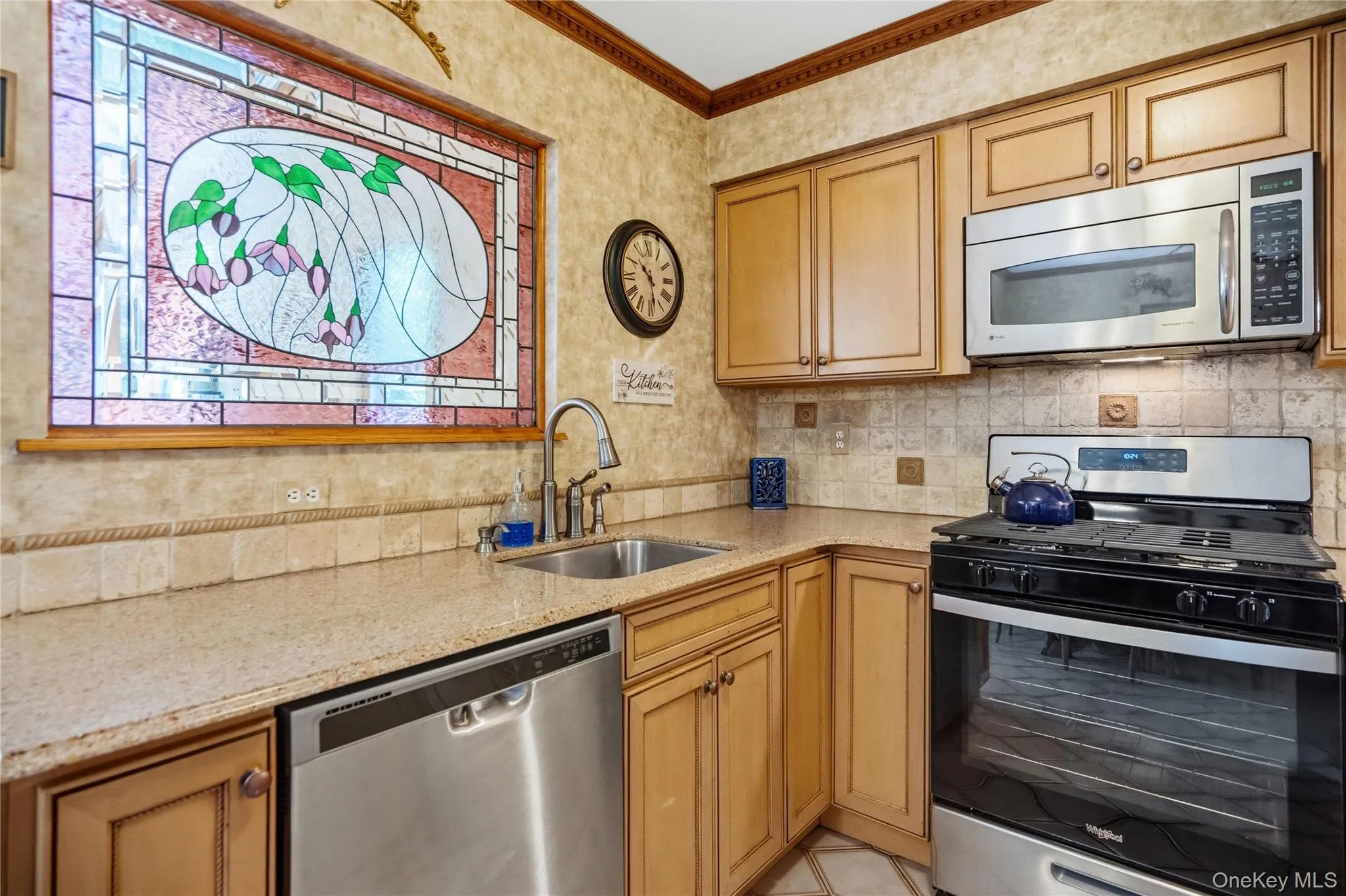 The warmth of this room is accentuated by the stained glass accent window, which gets bathed in natural light from the adjoining sunroom behind it. This combination of character & functionality make the kitchen a perfect setting for cooking, gathering or entertaining. The warmth of this room is accentuated by the stained glass accent window, which gets bathed in natural light from the adjoining sunroom behind it. This combination of character & functionality make the kitchen a perfect setting for cooking, gathering or entertaining.