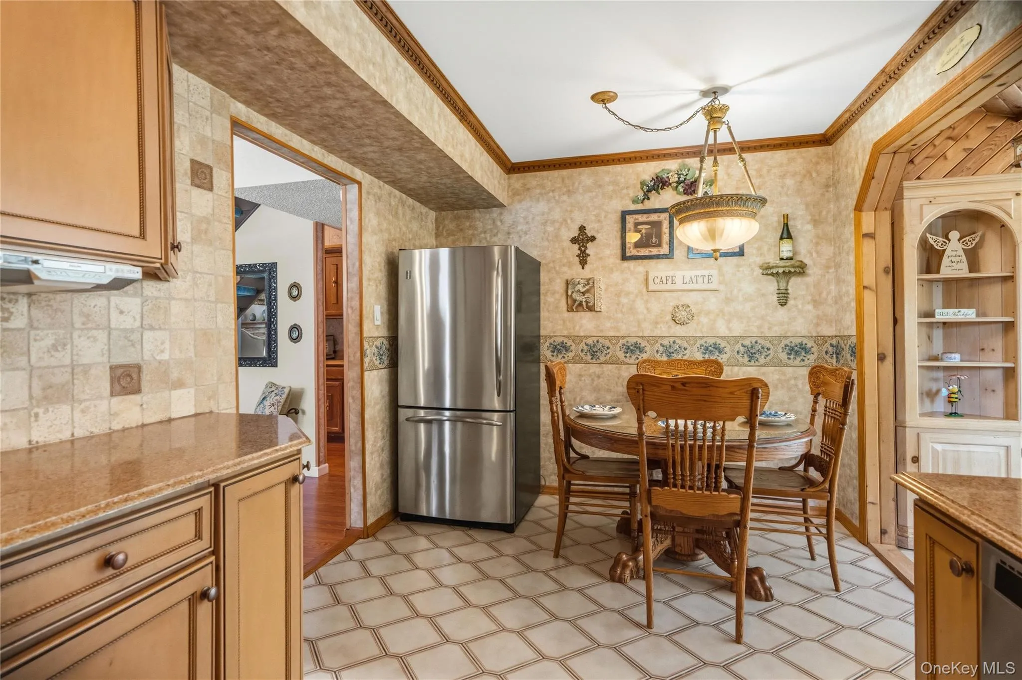Near the refrigerator, is an inviting dining area that comfortably accommodates everyday meals and casual gatherings. Near the refrigerator, is an inviting dining area that comfortably accommodates everyday meals and casual gatherings.