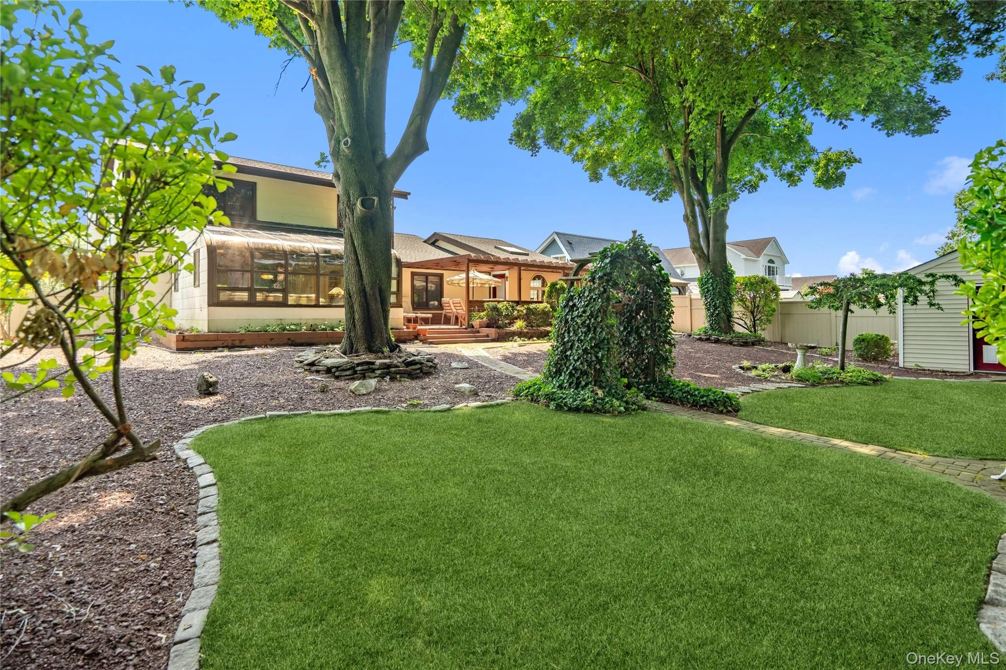 This peaceful backyard retreat features mature shade trees... This peaceful backyard retreat features mature shade trees...