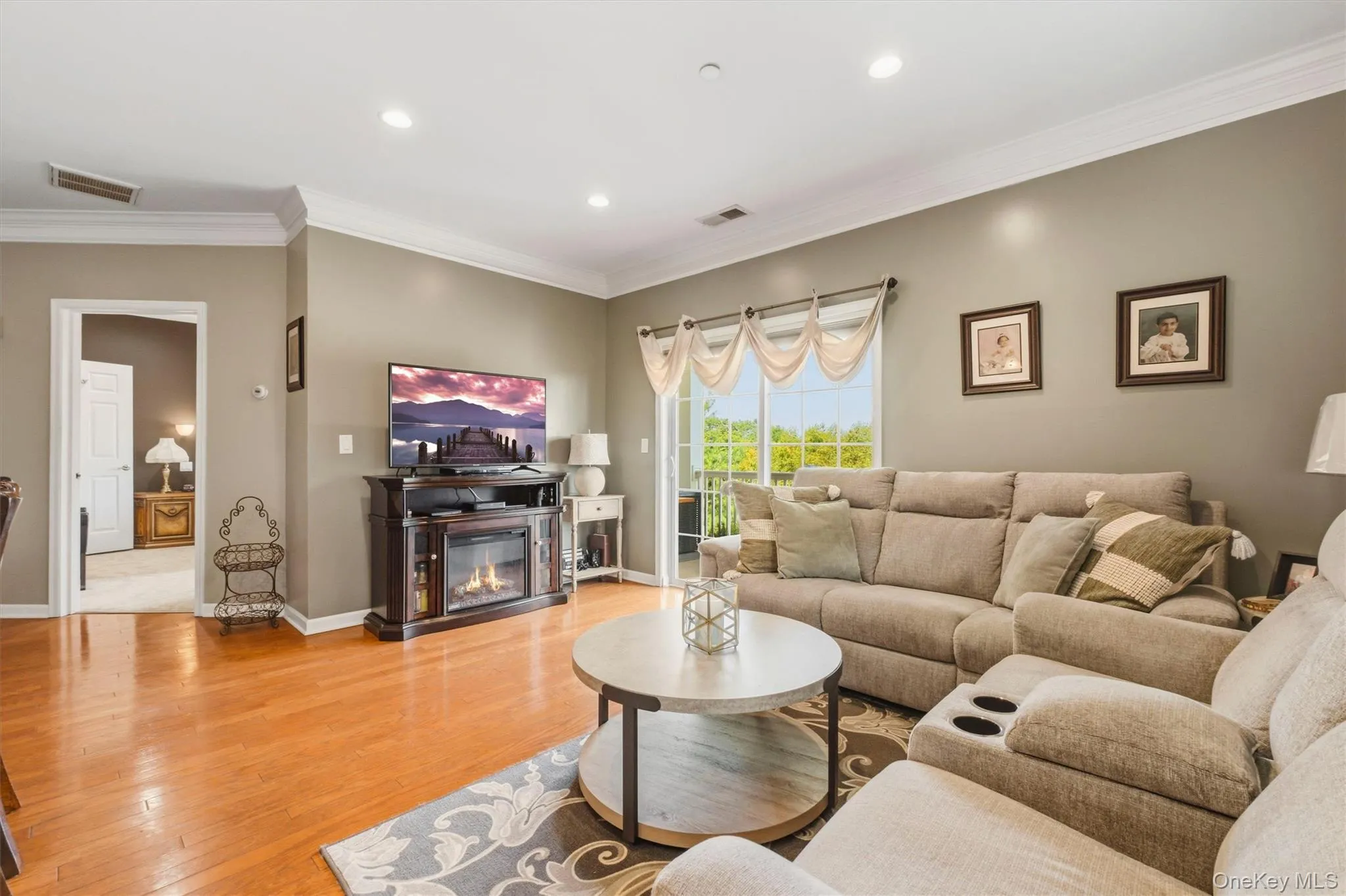 The spacious family room is a standout feature, offering a bright and inviting atmosphere enhanced by a dramatic wall of windows that capture beautiful seasonal river views. Filled with natural light throughout the day, this welcoming space is complemented by gleaming hardwood floors, creating the perfect setting for both relaxed everyday living and effortless entertaining. The spacious family room is a standout feature, offering a bright and inviting atmosphere enhanced by a dramatic wall of windows that capture beautiful seasonal river views. Filled with natural light throughout the day, this welcoming space is complemented by gleaming hardwood floors, creating the perfect setting for both relaxed everyday living and effortless entertaining.
