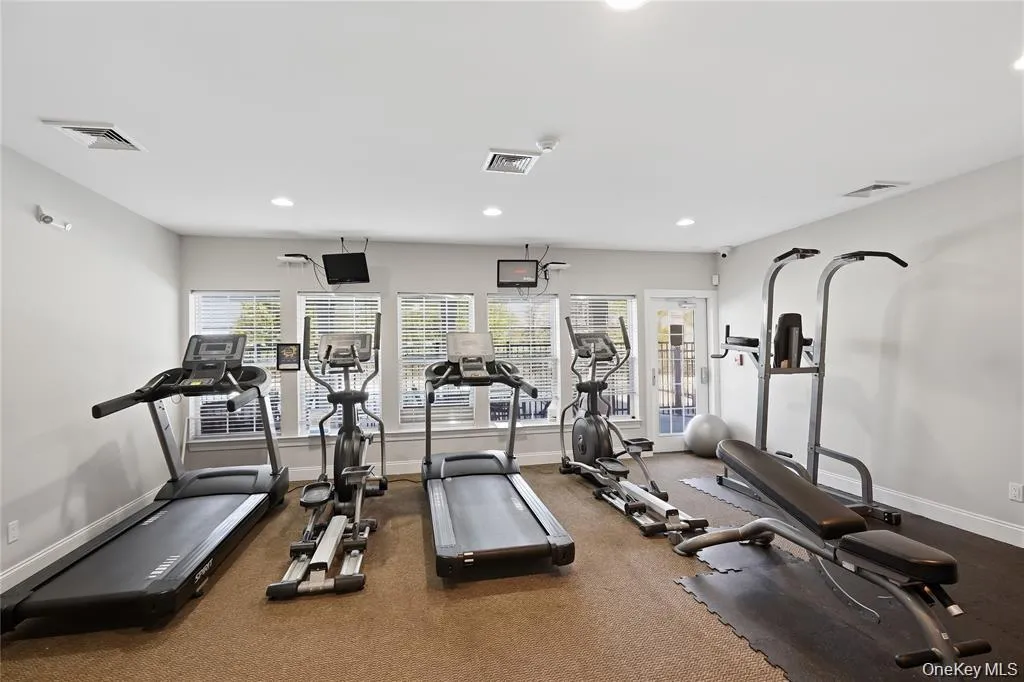 A bright and energizing cardio zone lined with large windows, allowing natural light to pour in while you enjoy treadmills, ellipticals, and bikes—creating an uplifting environment for your daily fitness routine. A bright and energizing cardio zone lined with large windows, allowing natural light to pour in while you enjoy treadmills, ellipticals, and bikes—creating an uplifting environment for your daily fitness routine.