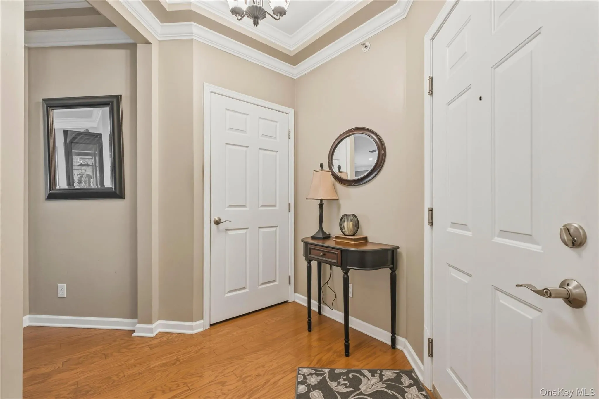 A grand entry foyer showcases Toll Brothers' signature craftsmanship with tray ceilings, decorative moldings, and rich hardwood flooring. This inviting space offers a graceful transition into the home's open living areas while making a memorable first impression of quality, style, and attention to detail. A grand entry foyer showcases Toll Brothers' signature craftsmanship with tray ceilings, decorative moldings, and rich hardwood flooring. This inviting space offers a graceful transition into the home's open living areas while making a memorable first impression of quality, style, and attention to detail.