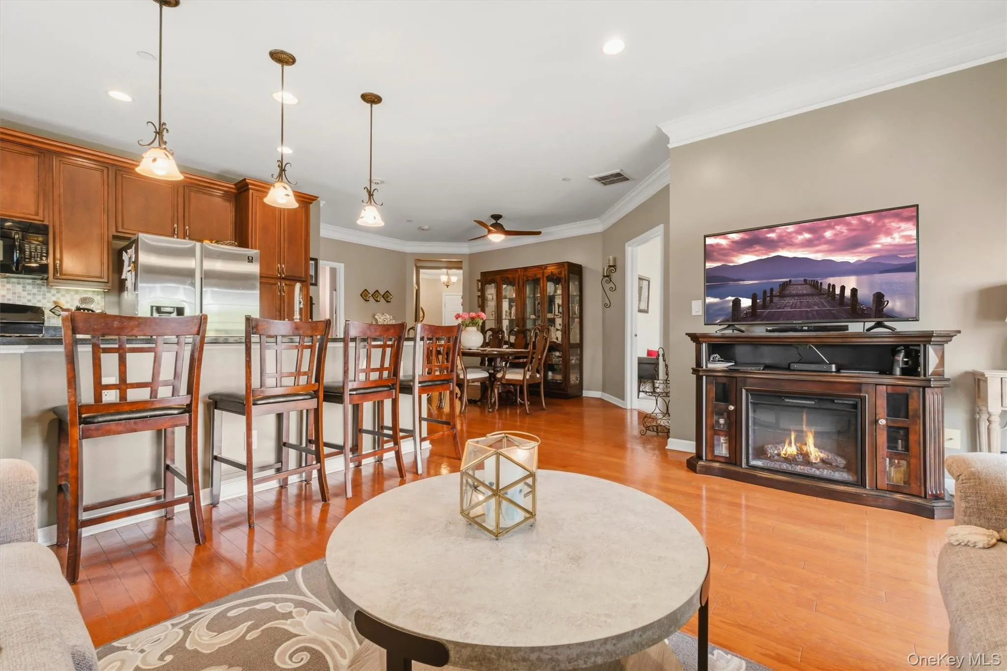 At the opposite end of the family room, a spacious formal dining area awaits, highlighted by an elegant chandelier and the same gleaming hardwood floors, flowing seamlessly into the kitchen—perfect for both intimate dinners and entertaining. At the opposite end of the family room, a spacious formal dining area awaits, highlighted by an elegant chandelier and the same gleaming hardwood floors, flowing seamlessly into the kitchen—perfect for both intimate dinners and entertaining.