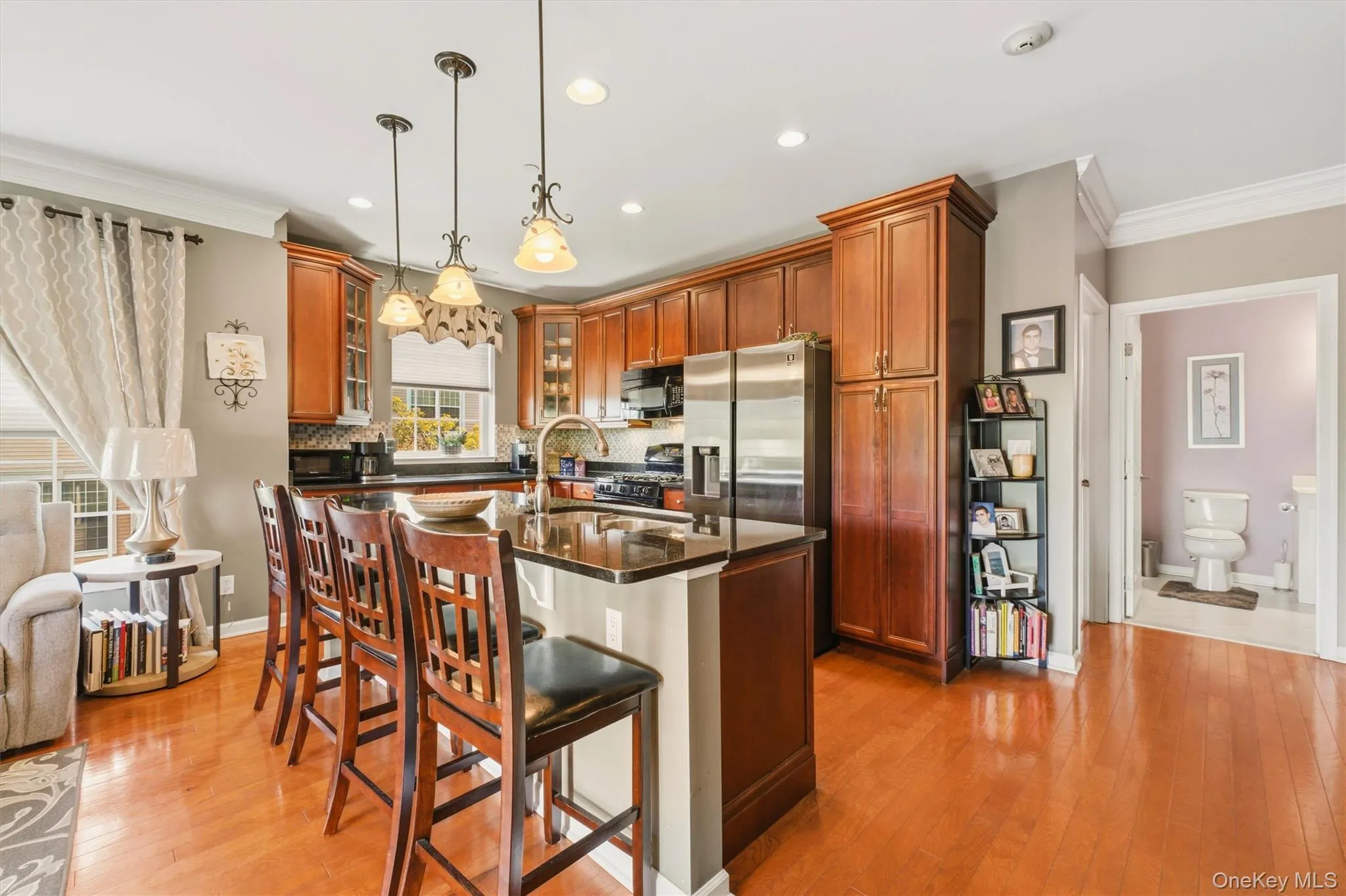 This magnificent kitchen is a chef’s dream, showcasing upgrades galore and a layout designed for both elegance and functionality. Featuring custom cherry cabinetry, including a stunning custom-designed design, this space exudes craftsmanship and sophistication. Expansive granite countertops provide an abundance of workspace, perfect for preparing meals or entertaining guests. The eat in island comfortably seats four and adds even more functionality to the heart of the home. This magnificent kitchen is a chef’s dream, showcasing upgrades galore and a layout designed for both elegance and functionality. Featuring custom cherry cabinetry, including a stunning custom-designed design, this space exudes craftsmanship and sophistication. Expansive granite countertops provide an abundance of workspace, perfect for preparing meals or entertaining guests. The eat in island comfortably seats four and adds even more functionality to the heart of the home.