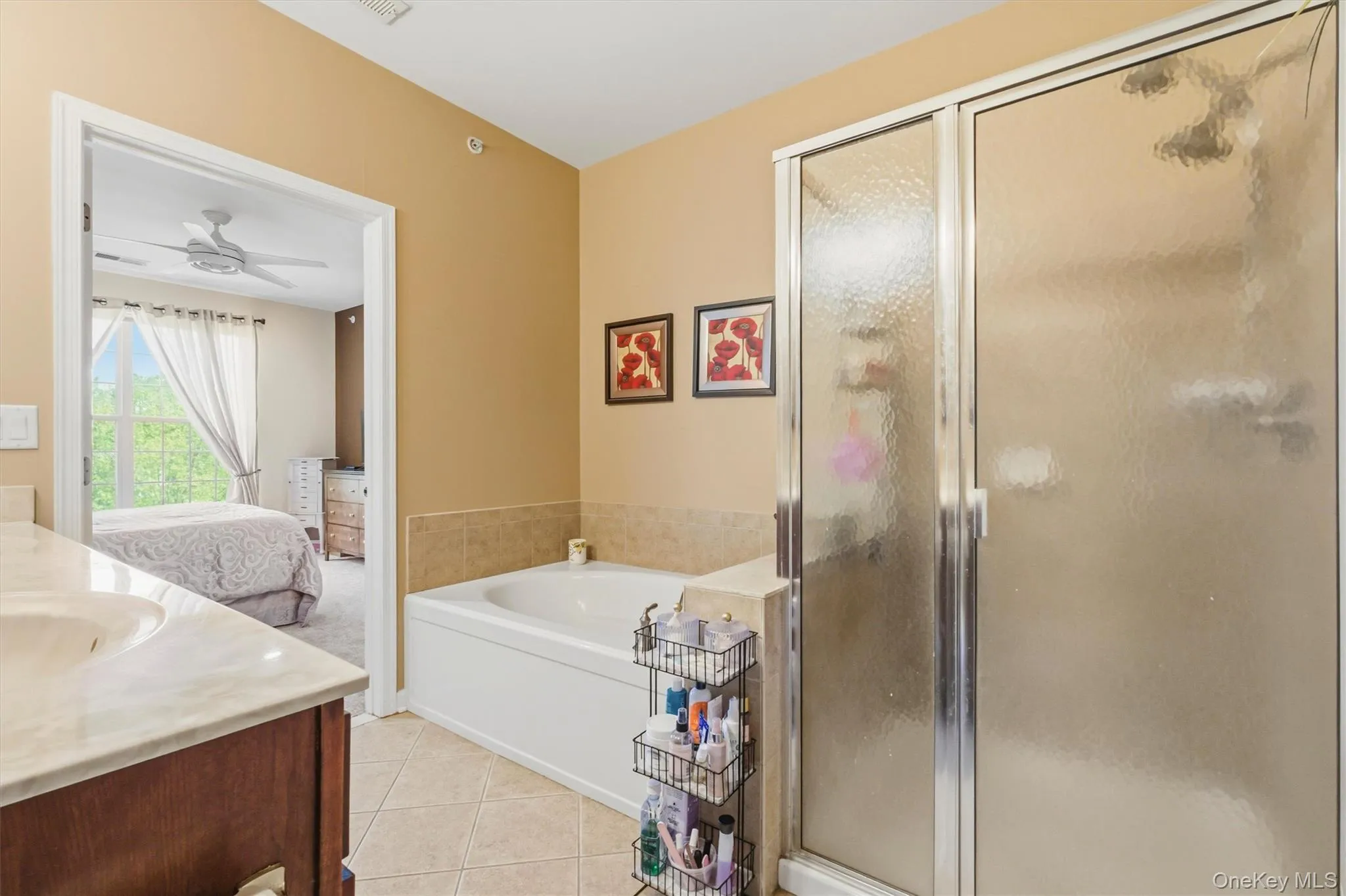 Features a luxurious whirlpool soaking tub paired with a separate glass-enclosed shower, offering a serene, spa-inspired retreat perfect for relaxation and rejuvenation. Features a luxurious whirlpool soaking tub paired with a separate glass-enclosed shower, offering a serene, spa-inspired retreat perfect for relaxation and rejuvenation.