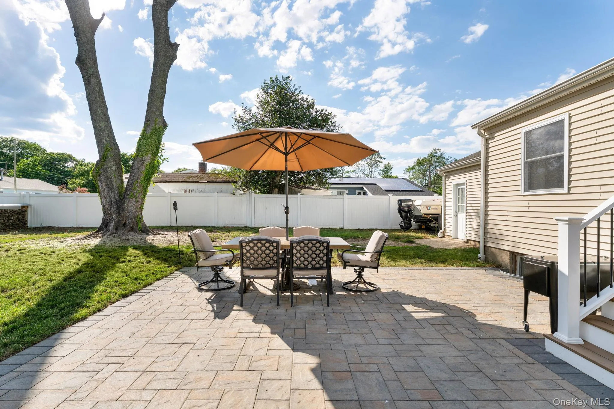 Expansive paver patio with direct access to a private backyard Expansive paver patio with direct access to a private backyard