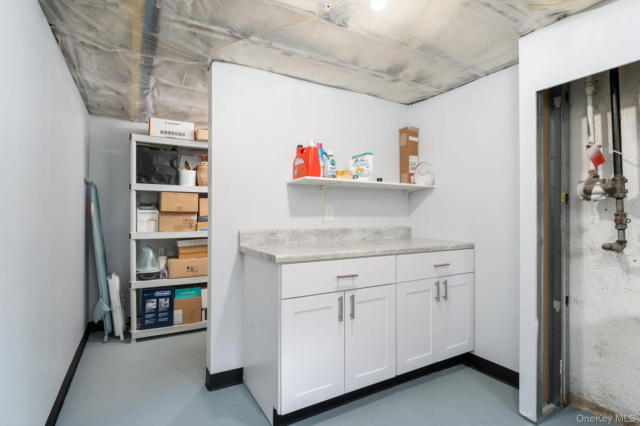 Part of dedicated basement Laundry area with cabinet storage. Part of dedicated basement Laundry area with cabinet storage.