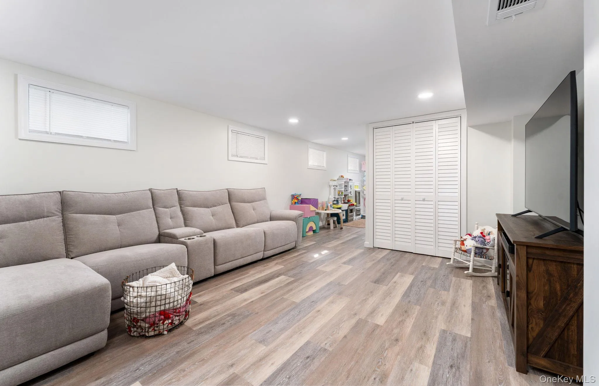 Finished interior space featuring wood-finish flooring (LVP) white walls, and recessed lighting Finished interior space featuring wood-finish flooring (LVP) white walls, and recessed lighting