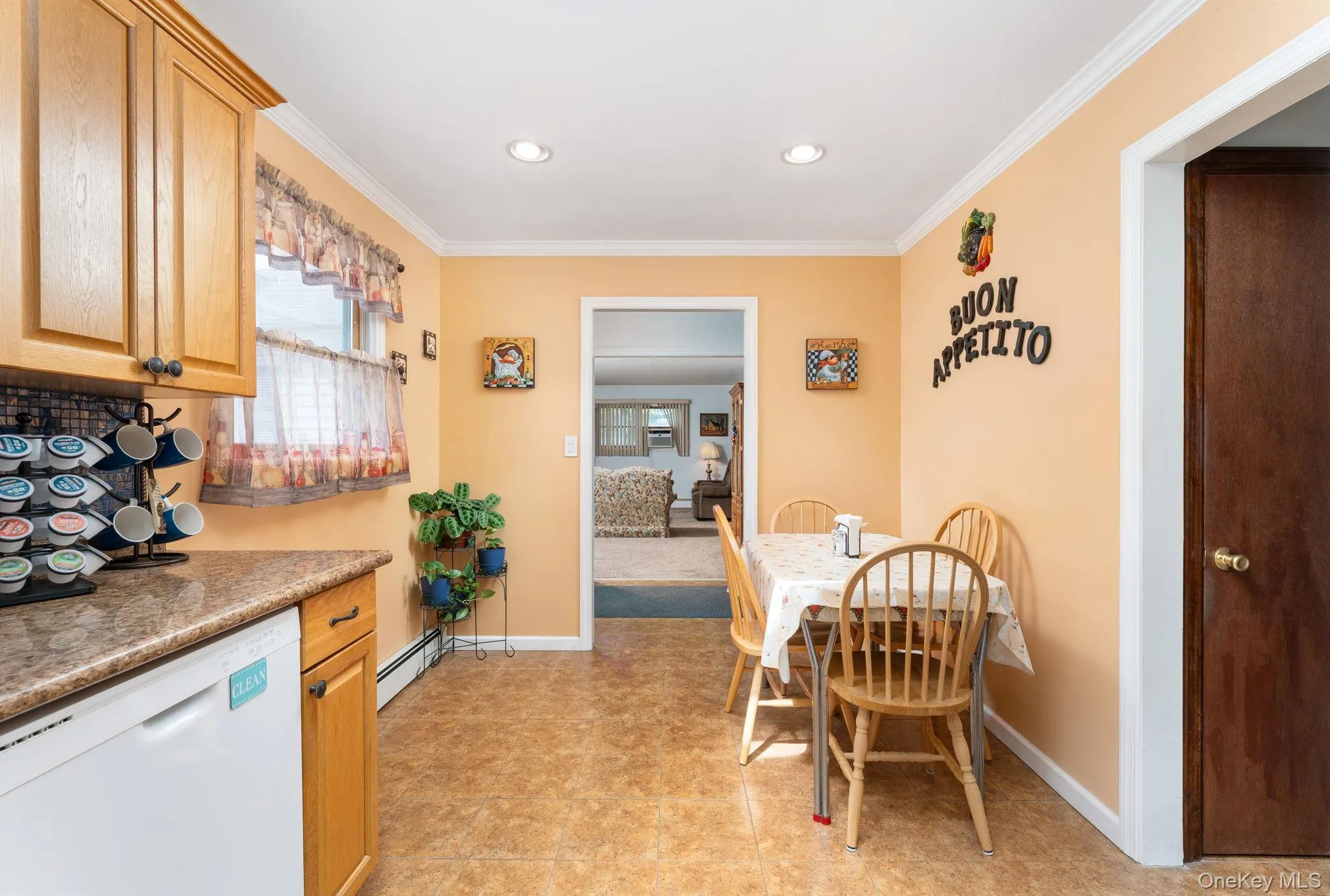 Kitchen with wood-finish cabinetry, speckled countertops, and a white dishwasher Kitchen with wood-finish cabinetry, speckled countertops, and a white dishwasher