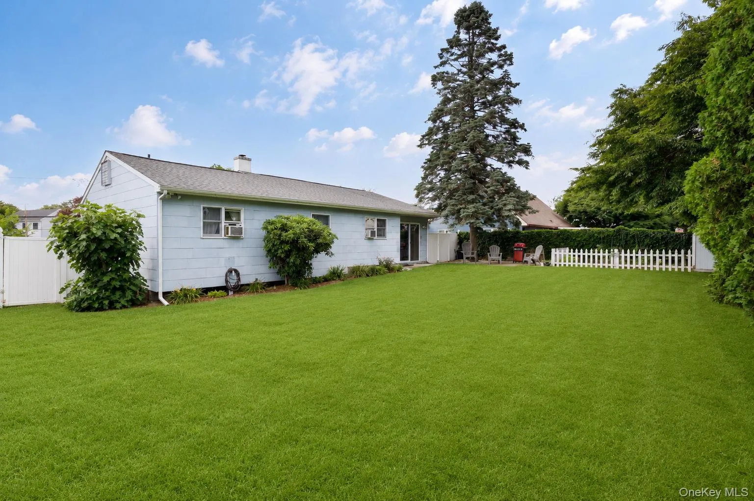 Expansive green lawn providing ample outdoor space Expansive green lawn providing ample outdoor space
