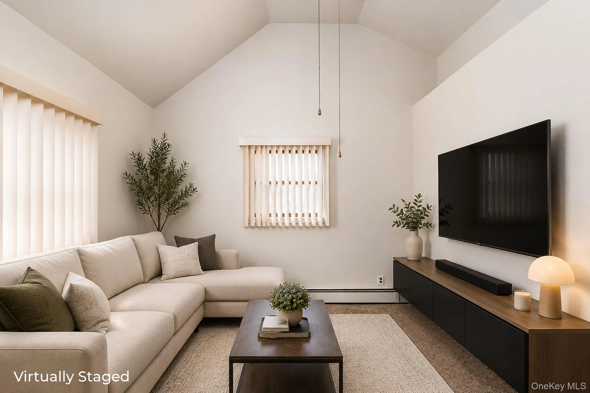 Vaulted ceiling living space featuring vertical blinds on multiple windows, a media console with a wood-finish top and dark cabinetry, and a neutral-toned carpet Vaulted ceiling living space featuring vertical blinds on multiple windows, a media console with a wood-finish top and dark cabinetry, and a neutral-toned carpet