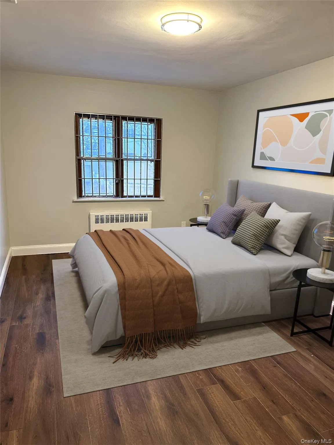 Room featuring wood-finish flooring, a window with security bars, a baseboard heating unit, and a flush-mount ceiling light fixture Room featuring wood-finish flooring, a window with security bars, a baseboard heating unit, and a flush-mount ceiling light fixture