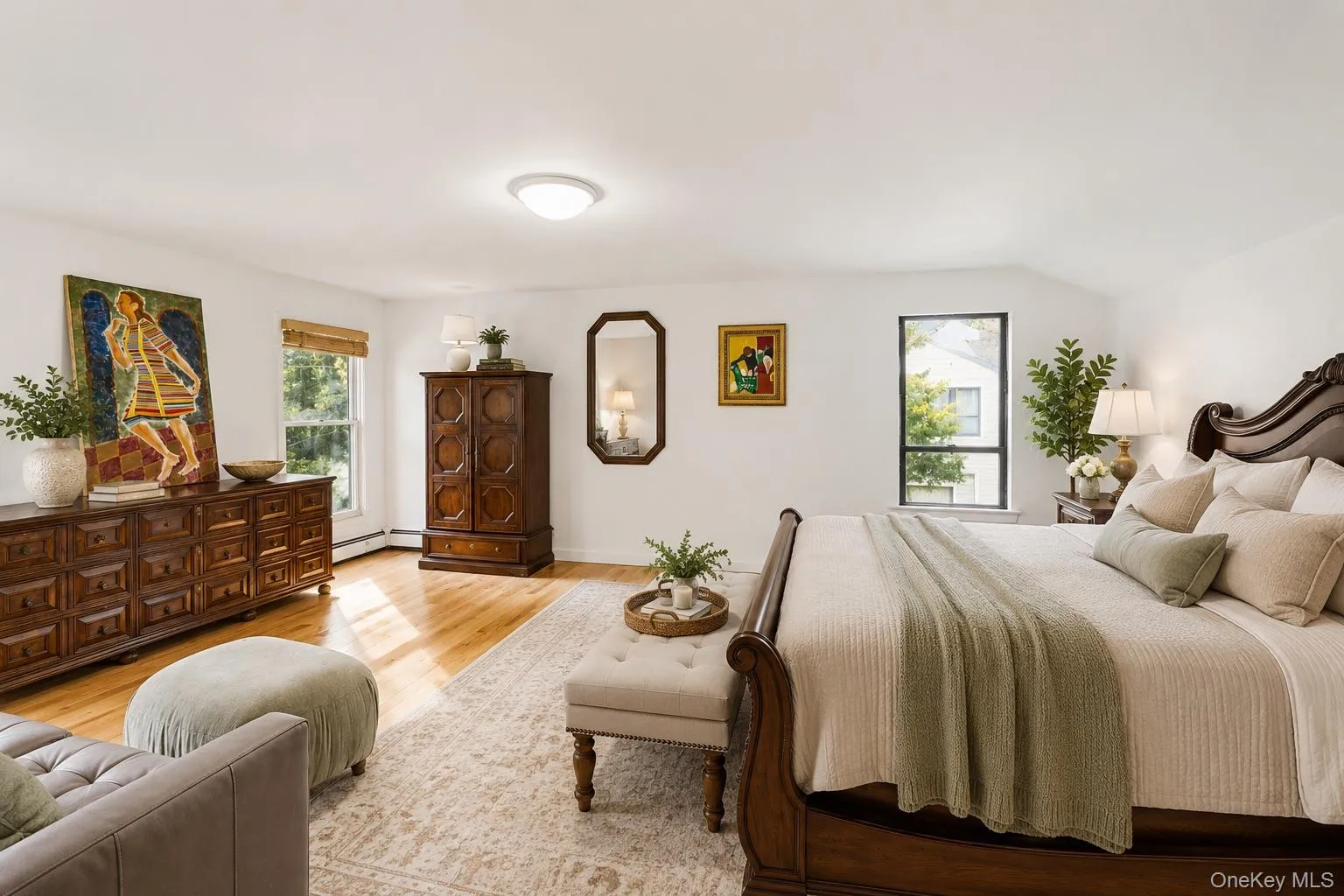 Bright bedroom featuring expansive wood-finish flooring Bright bedroom featuring expansive wood-finish flooring