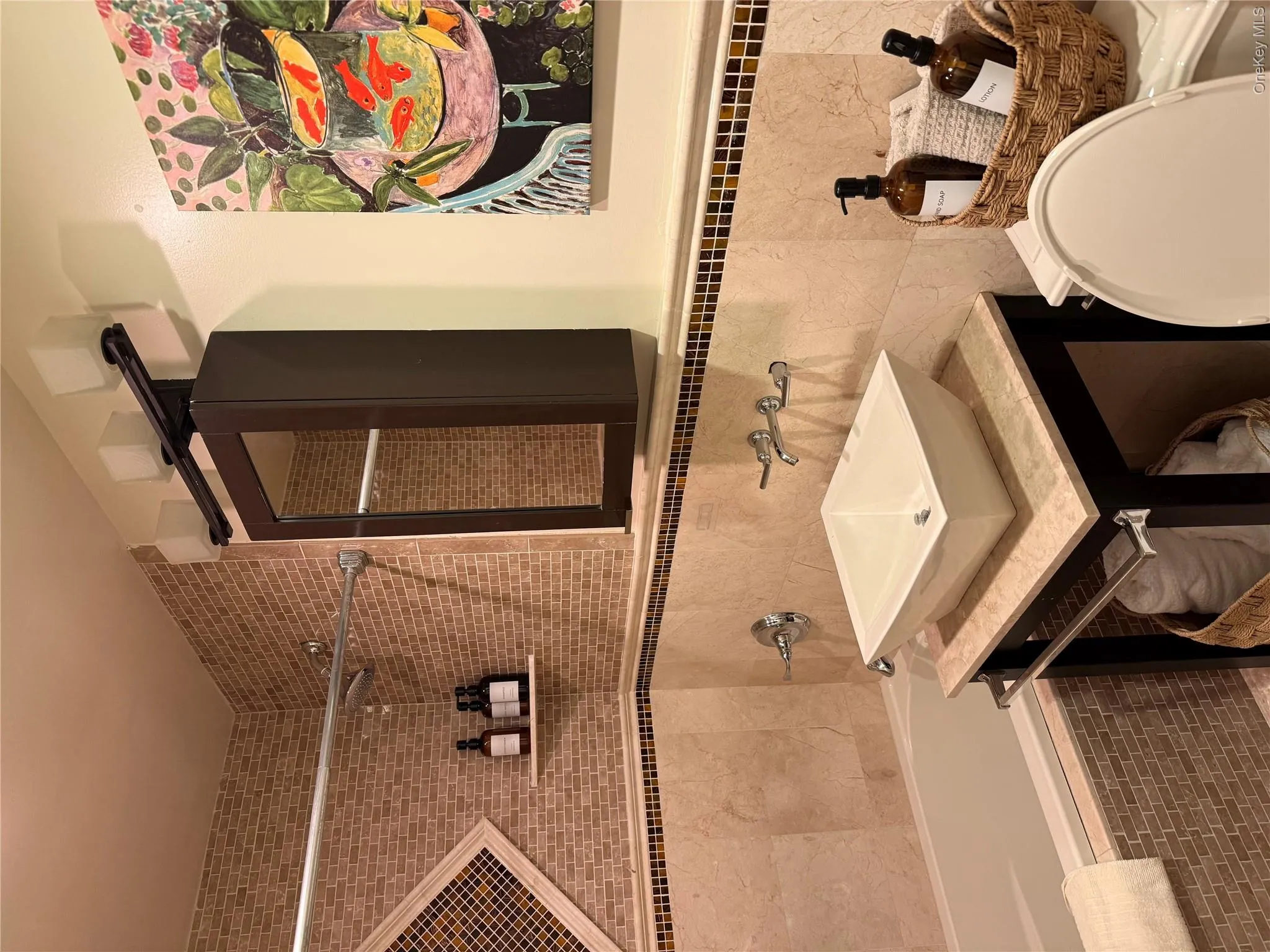 Bathroom featuring toilet, vanity, tile walls, and tiled shower / bath combo Bathroom featuring toilet, vanity, tile walls, and tiled shower / bath combo
